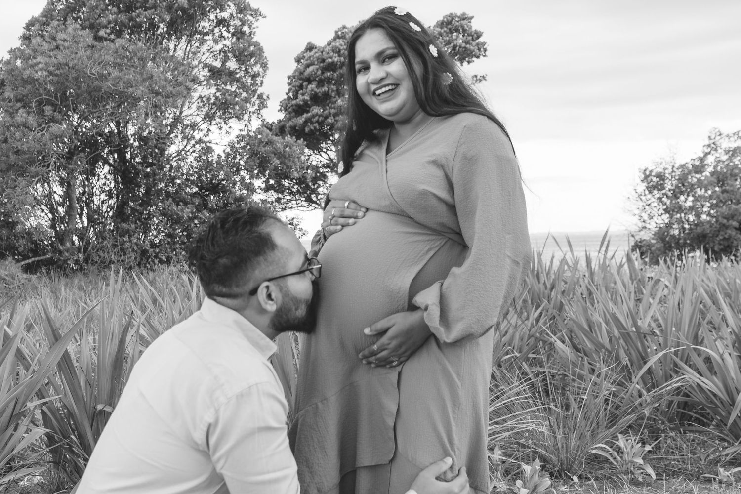 A magical maternity shoot during sunset at Long Bay Beach, Auckland.