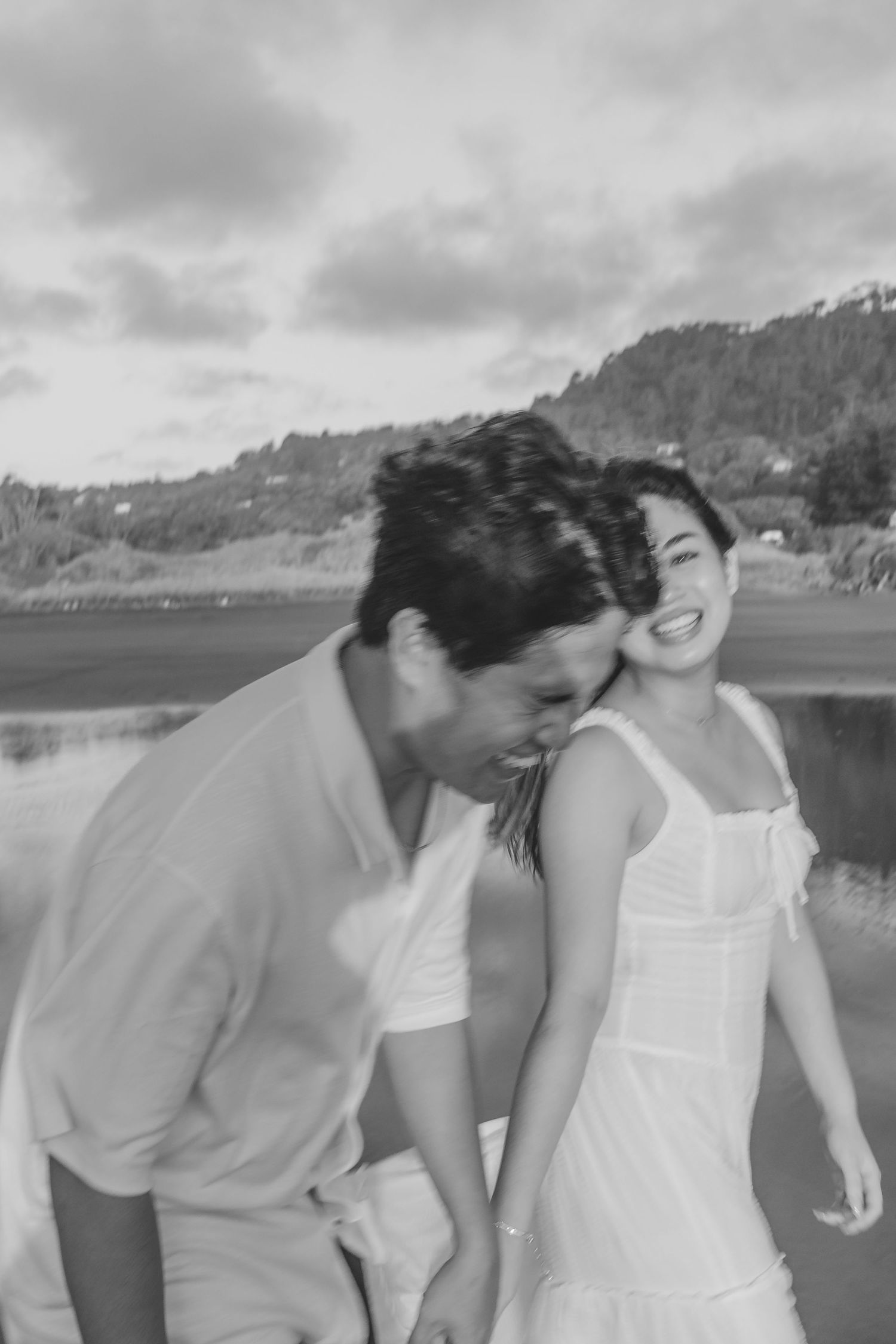 A couple photoshoot session during a magical sunset at Muriwai Beach by YM Photography.
