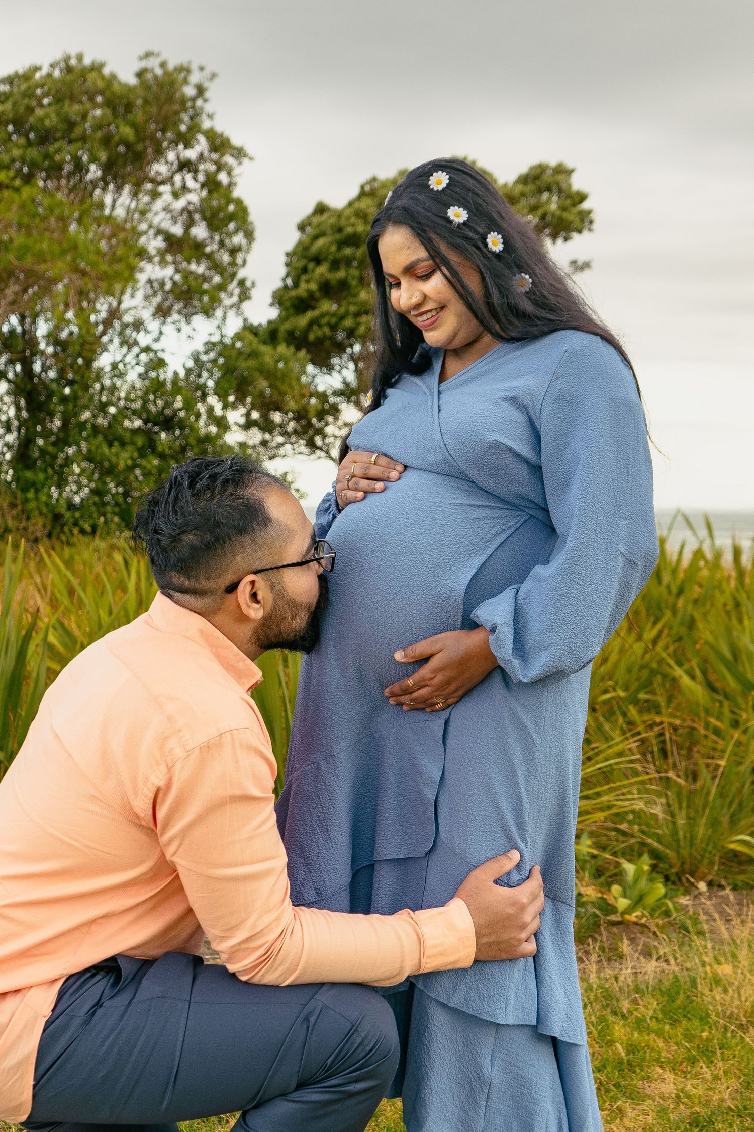 A magical maternity shoot during sunset at Long Bay Beach, Auckland.