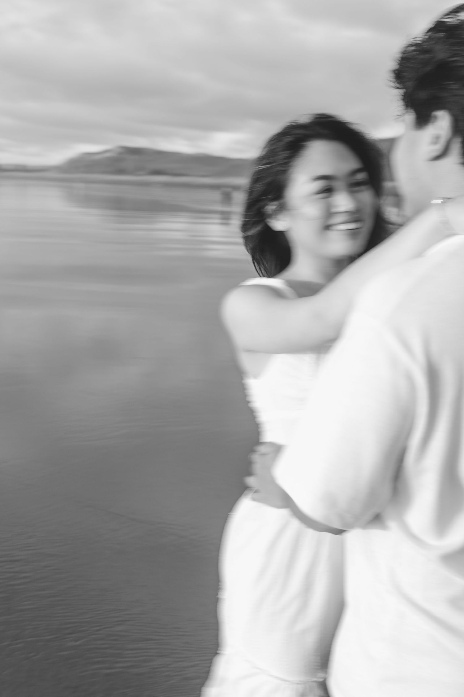 A couple photoshoot session during a magical sunset at Muriwai Beach by YM Photography.