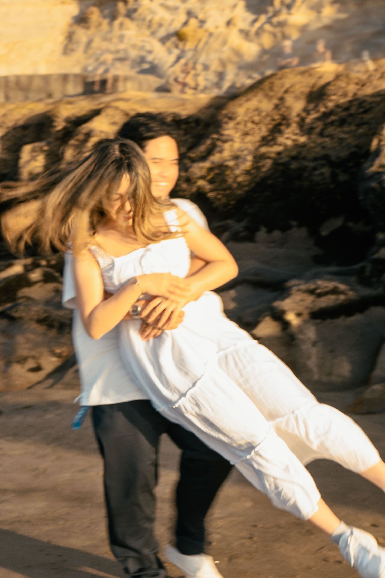A couple photoshoot session during a magical sunset at Muriwai Beach by YM Photography. Chasing sunsets