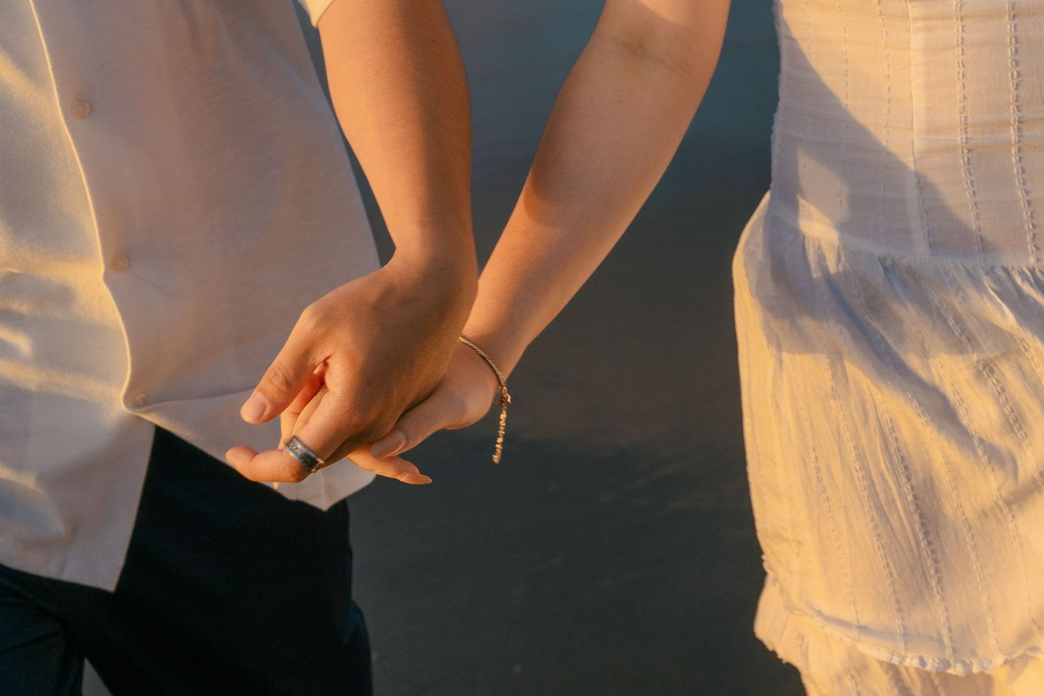 A couple photoshoot session during a magical sunset at Muriwai Beach by YM Photography.