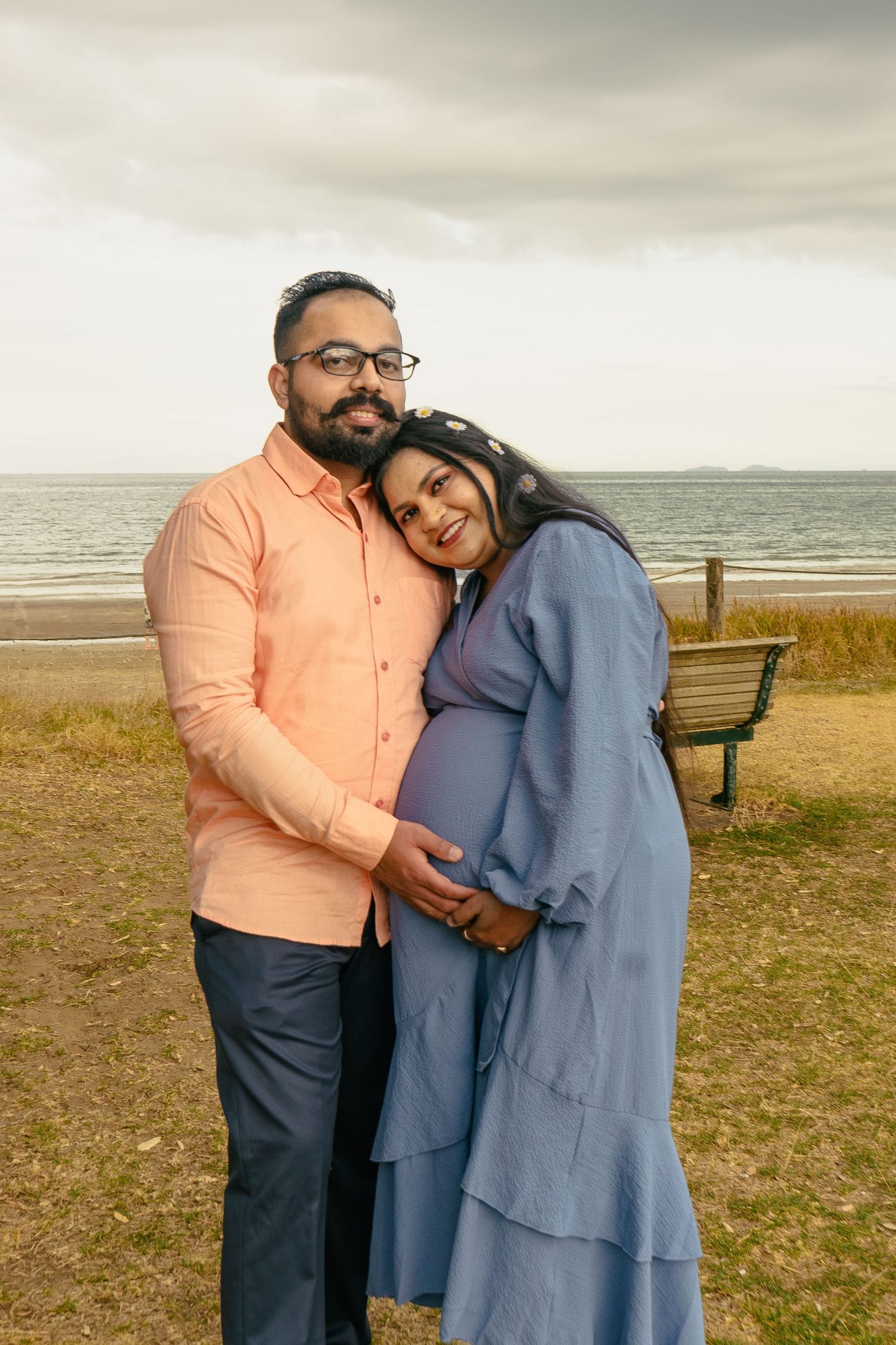A gorgeous maternity shoot during sunset at Long Bay Beach, Auckland by YM Photography. White, flowy maternity dress used from Shein.