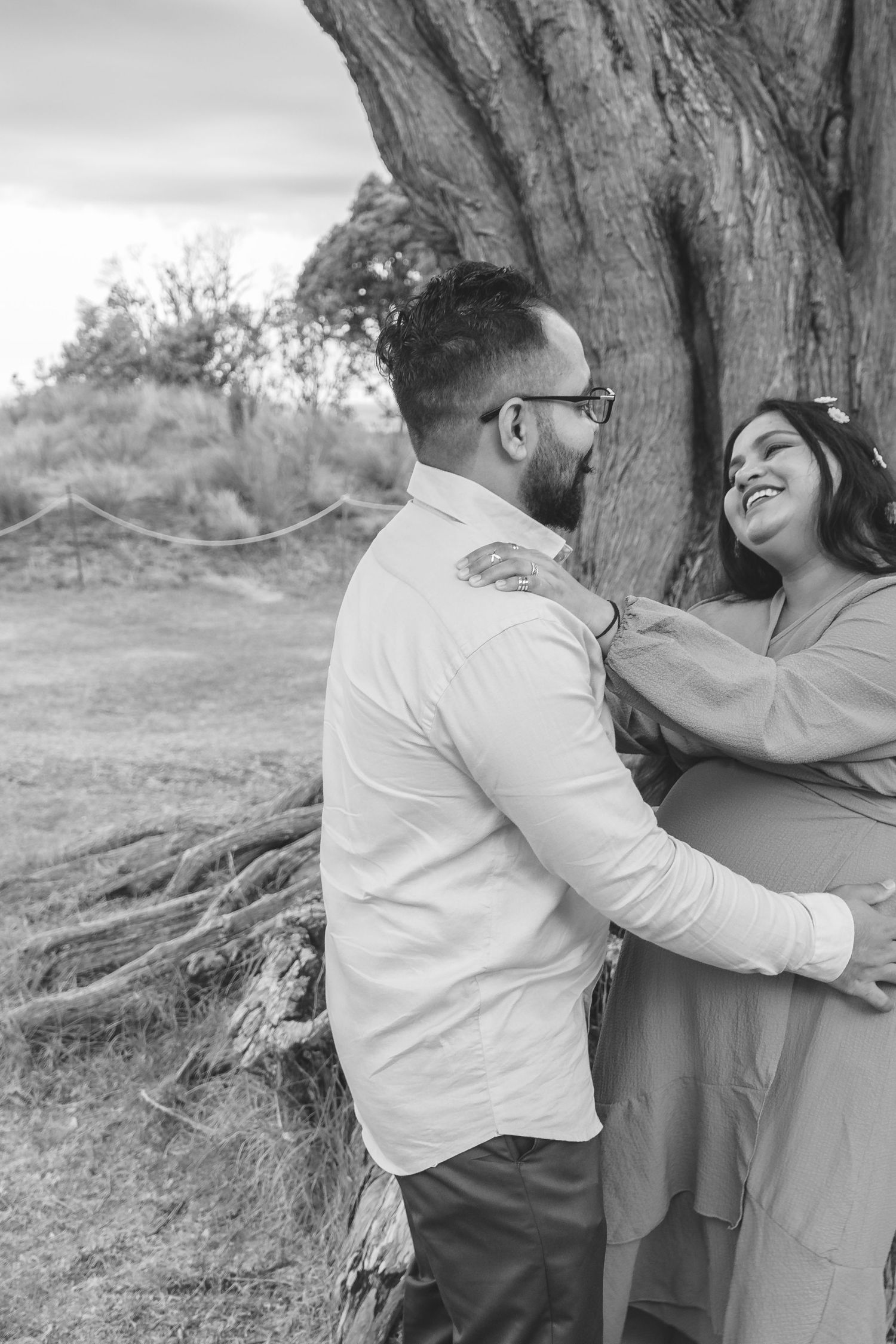 A gorgeous maternity shoot during sunset at Long Bay Beach, Auckland by YM Photography. White, flowy maternity dress used from Shein.