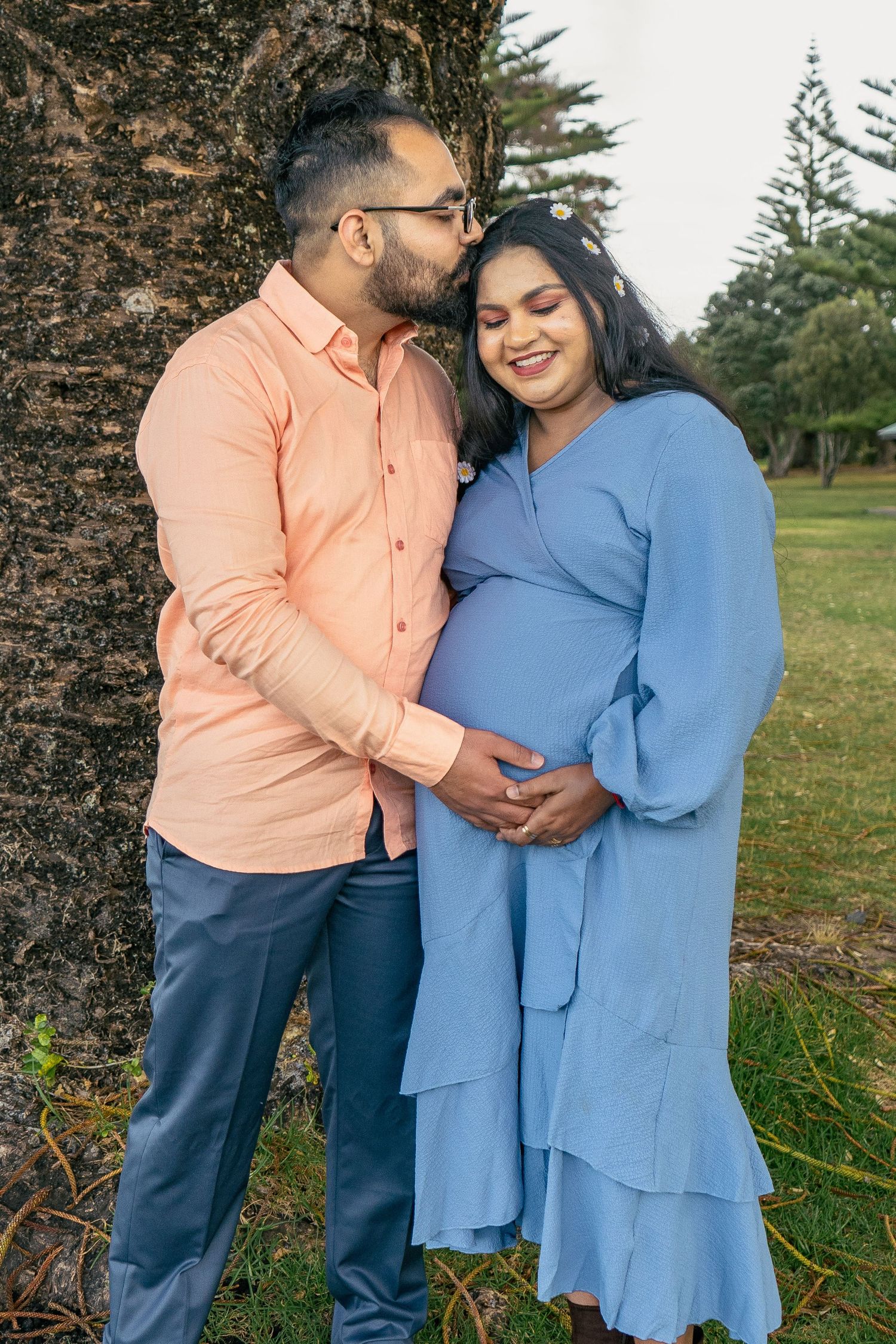 A gorgeous maternity shoot during sunset at Long Bay Beach, Auckland by YM Photography. White, flowy maternity dress used from Shein.