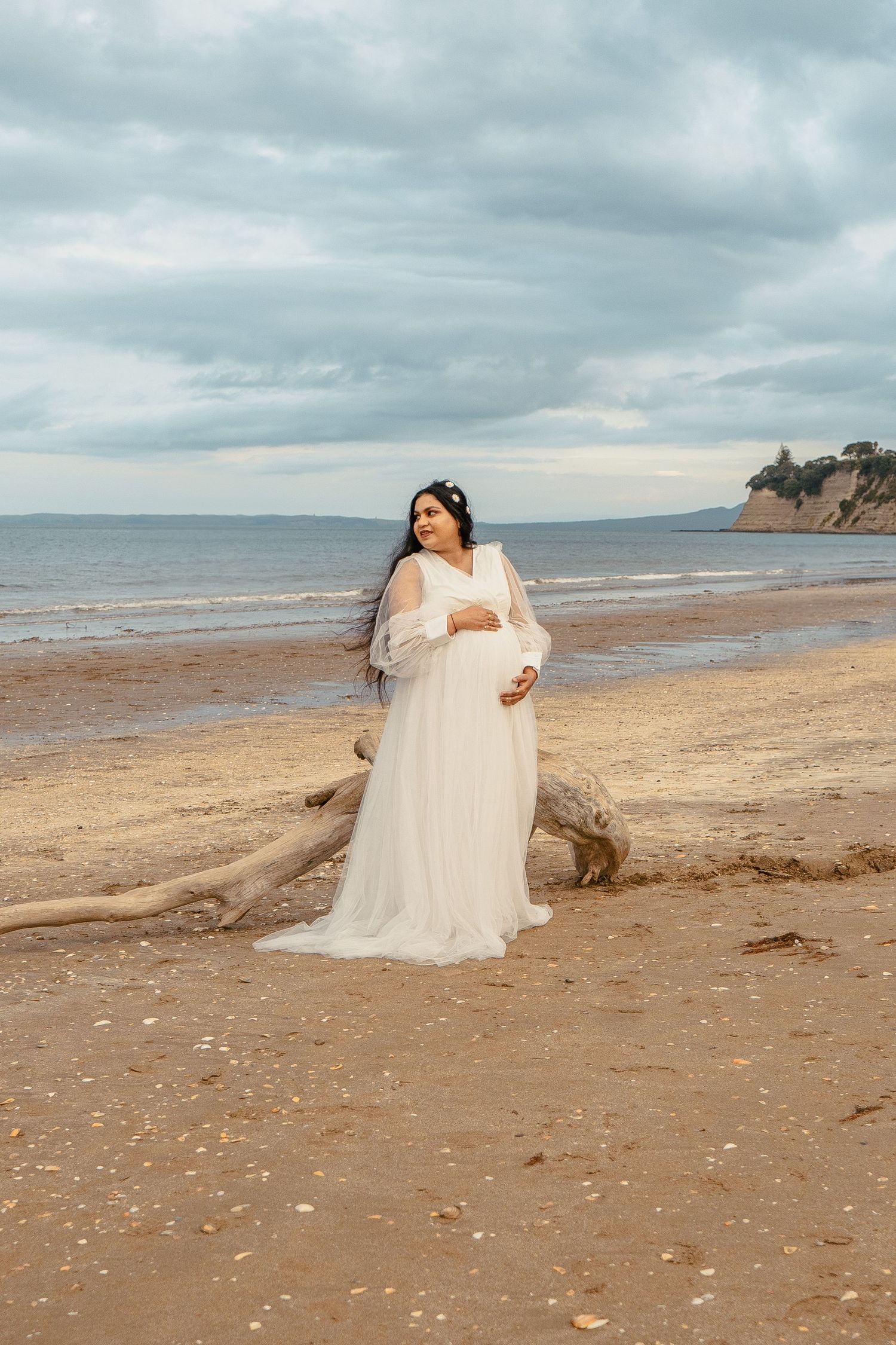 A magical maternity shoot during sunset at Long Bay Beach, Auckland.