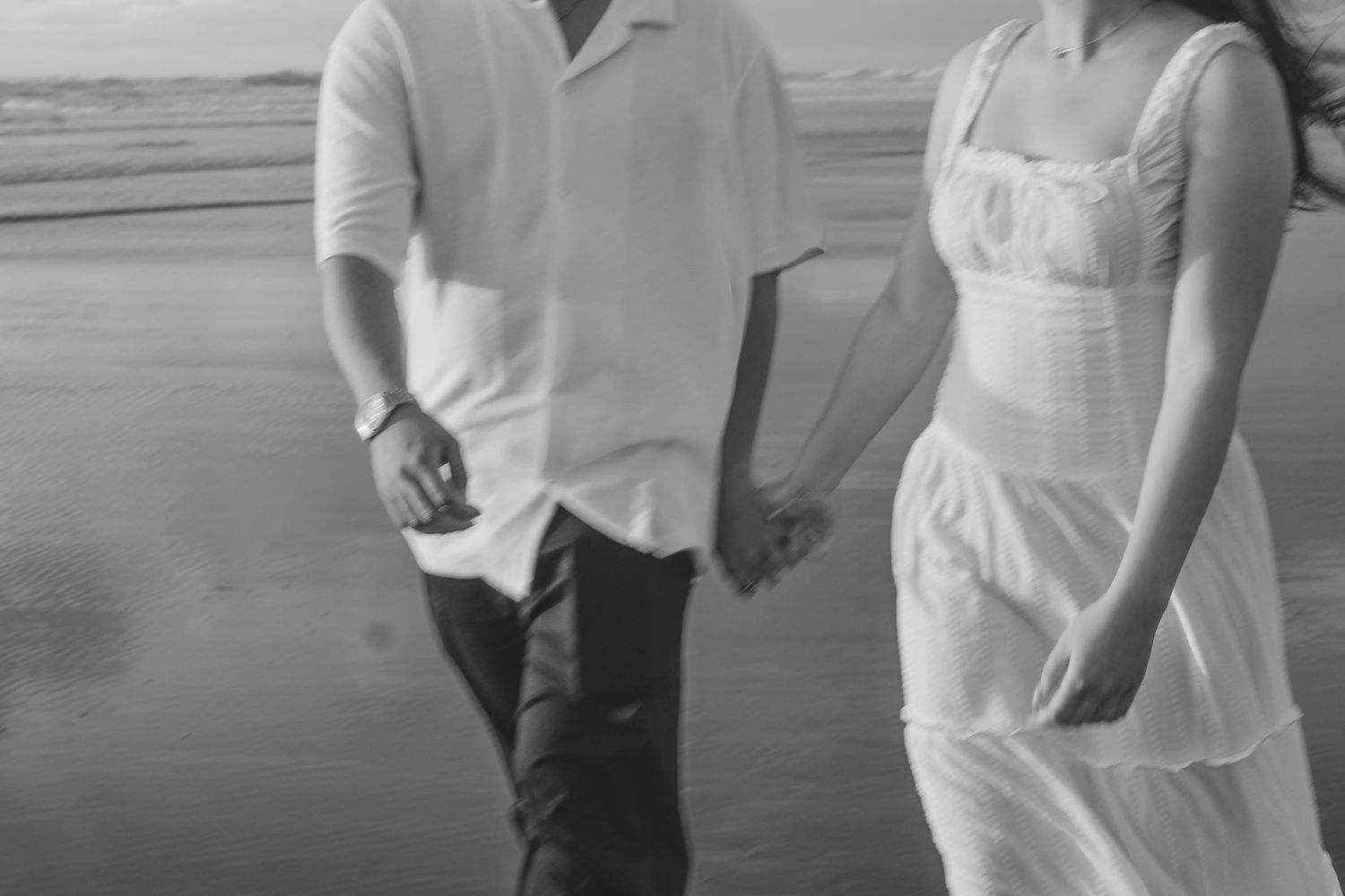 A couple photoshoot session during a magical sunset at Muriwai Beach by YM Photography.