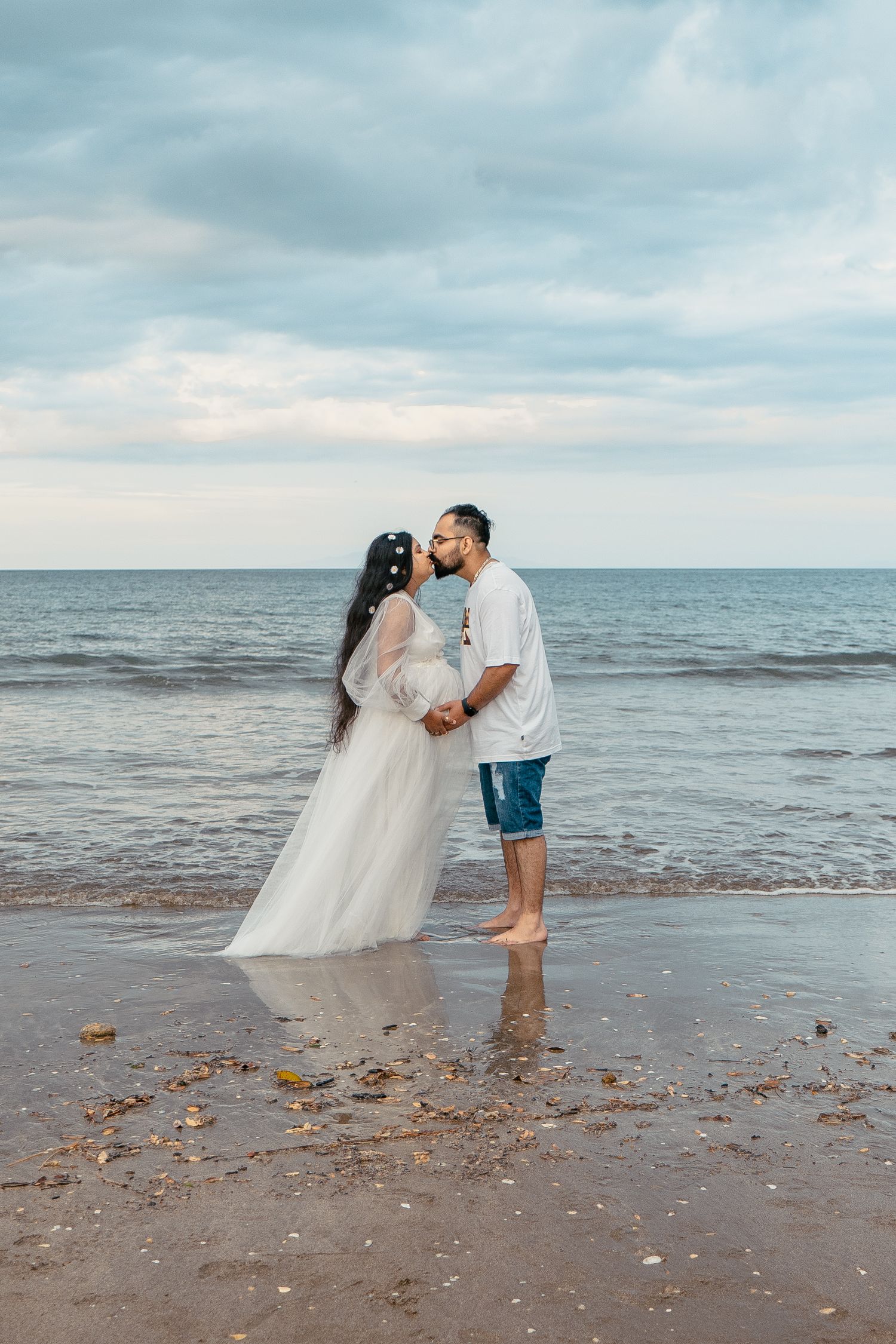 A gorgeous maternity shoot during sunset at Long Bay Beach, Auckland by YM Photography. White, flowy maternity dress used from Shein.
