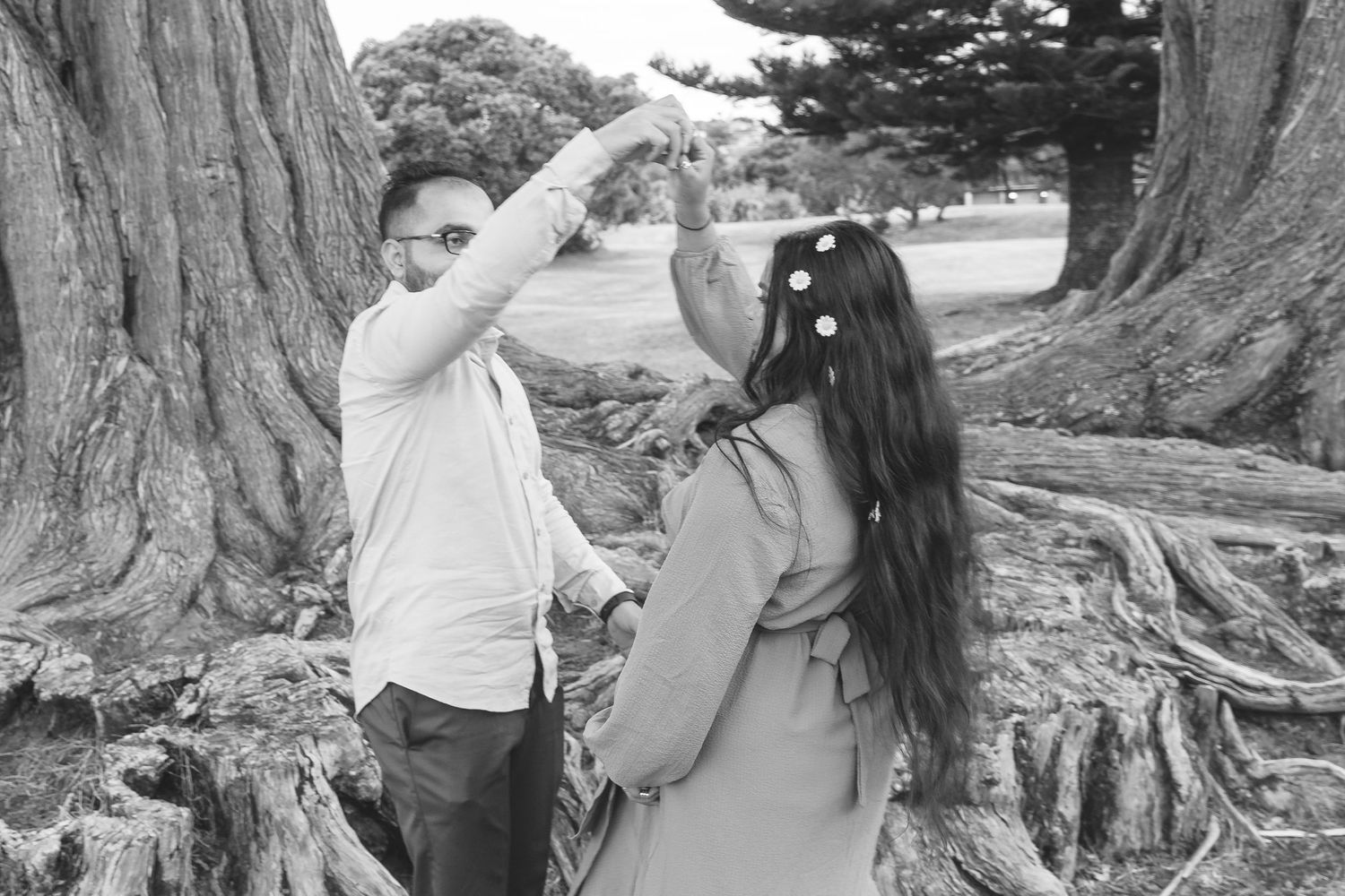 A gorgeous maternity shoot during sunset at Long Bay Beach, Auckland by YM Photography. White, flowy maternity dress used from Shein.
