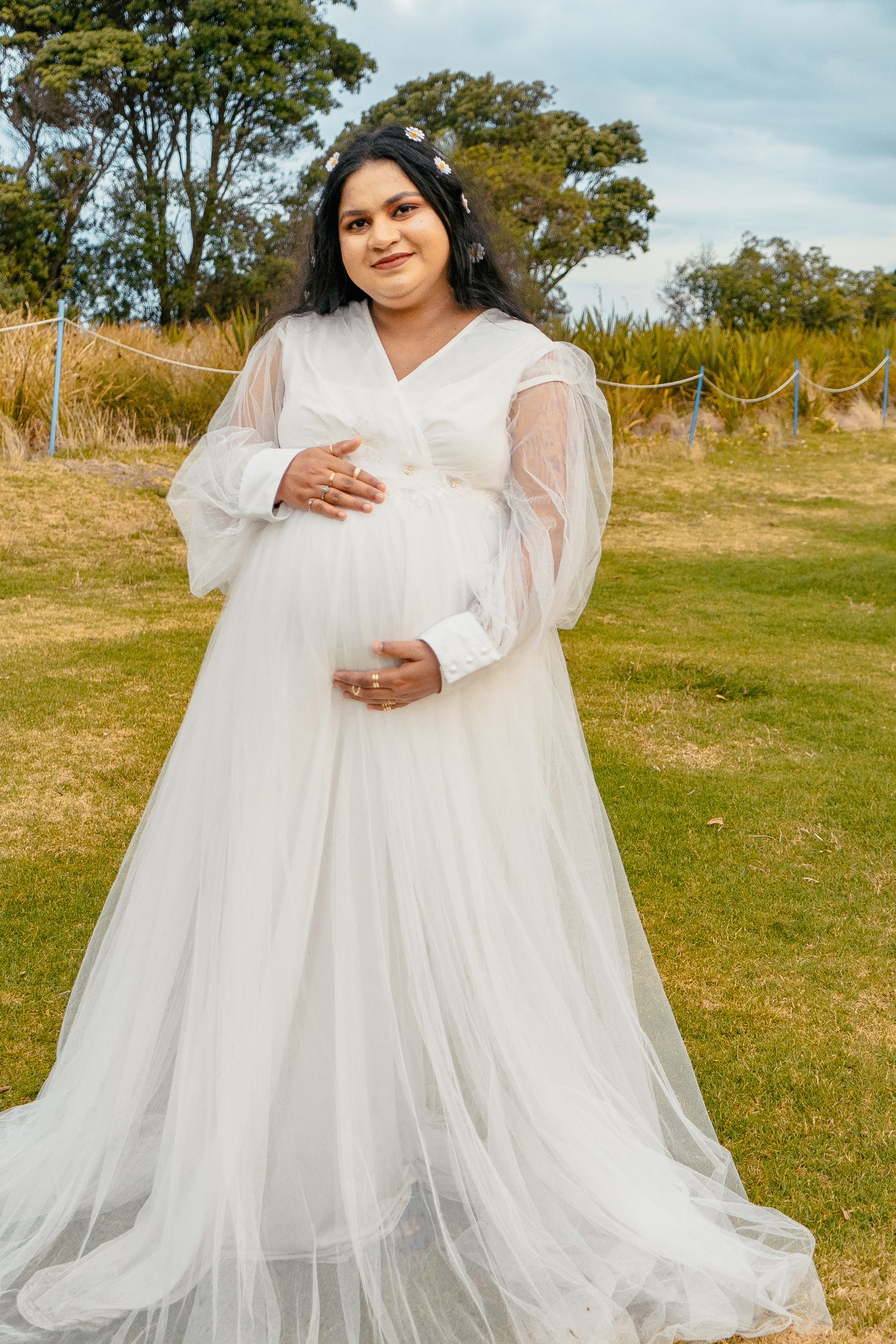 A magical maternity shoot during sunset at Long Bay Beach, Auckland.