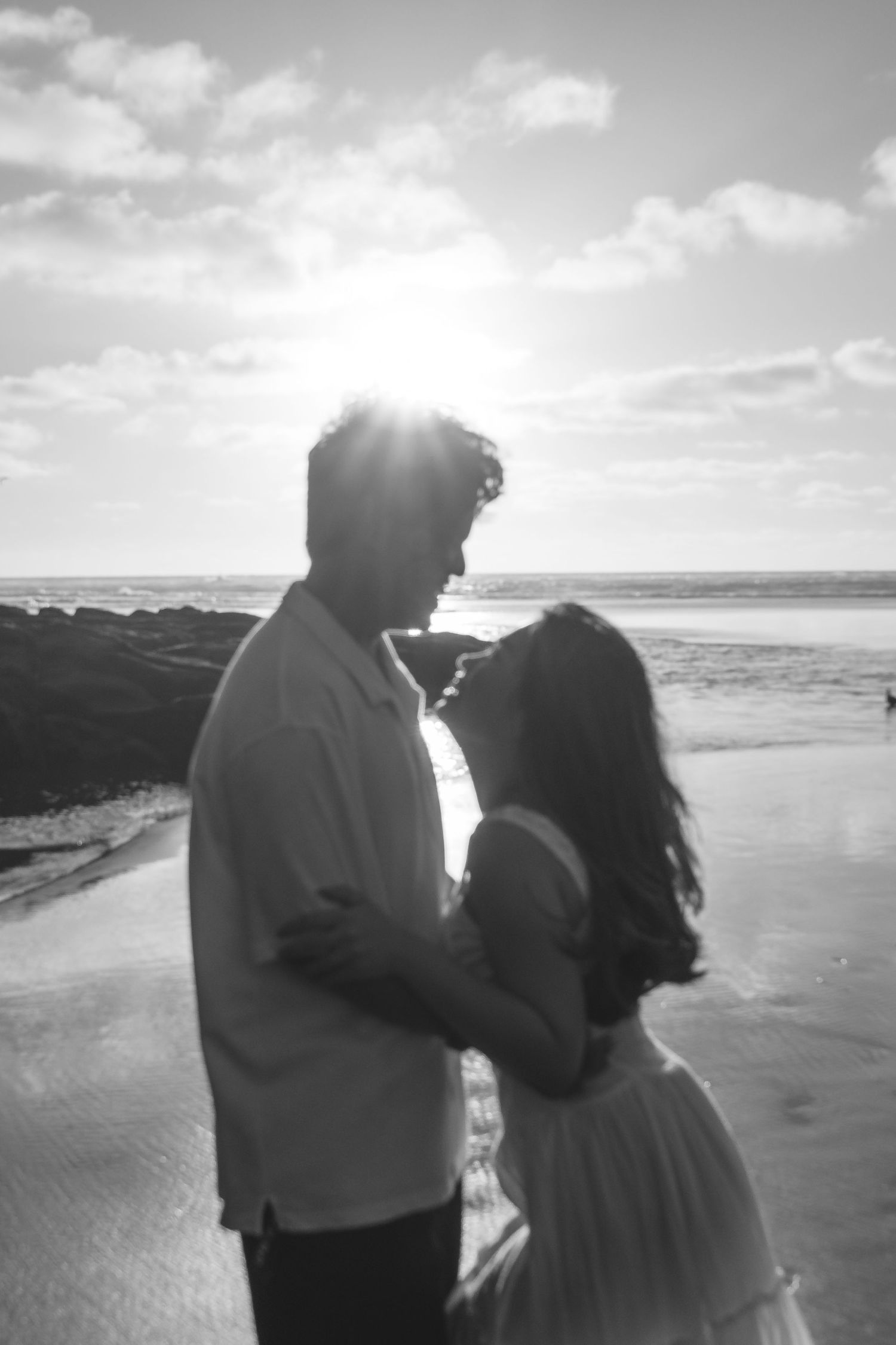 A couple photoshoot session during a magical sunset at Muriwai Beach by YM Photography. Chasing sunsets
