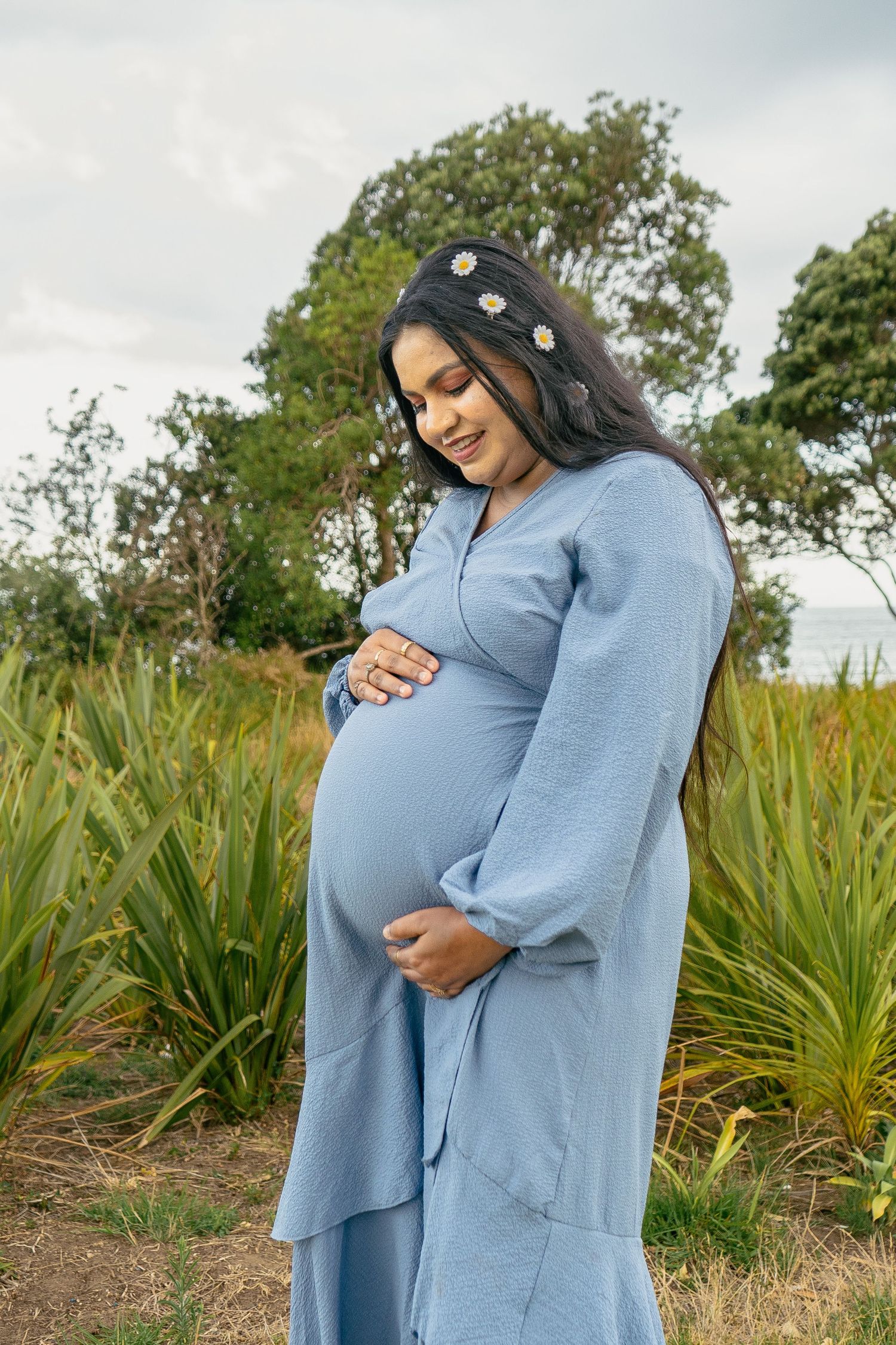 A magical maternity shoot during sunset at Long Bay Beach, Auckland.