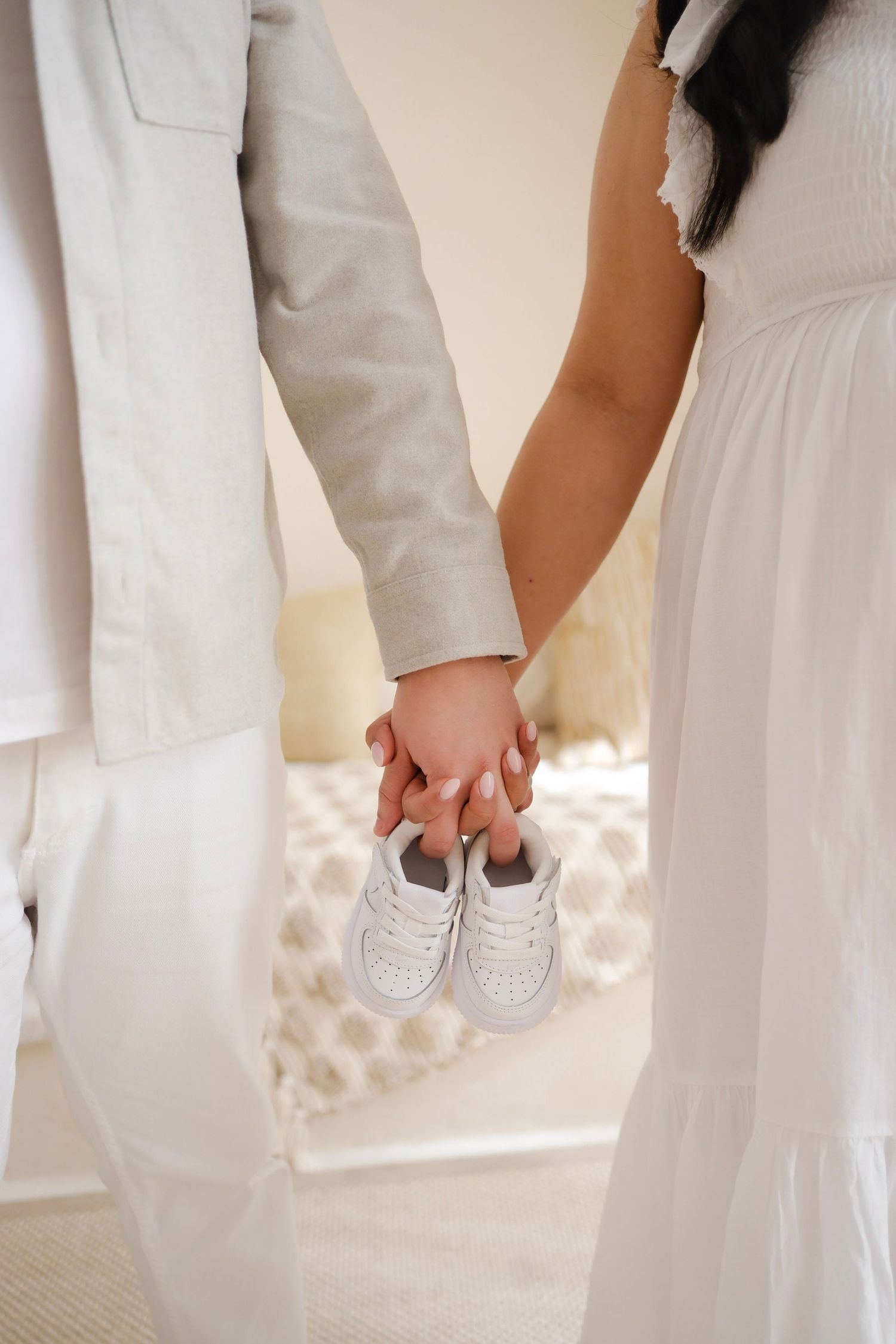 Couple holding tiny baby shoes together in intimate pregnancy announcement photo. Toronto, maternity photographer, toronto