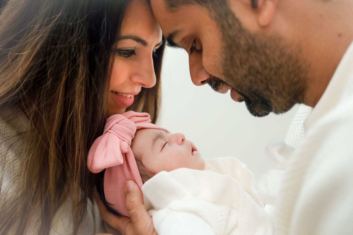 Parents sharing intimate moment with newborn in soft natural light setting. Toronto, Greater Toronto Area, photographer, toronto photography
