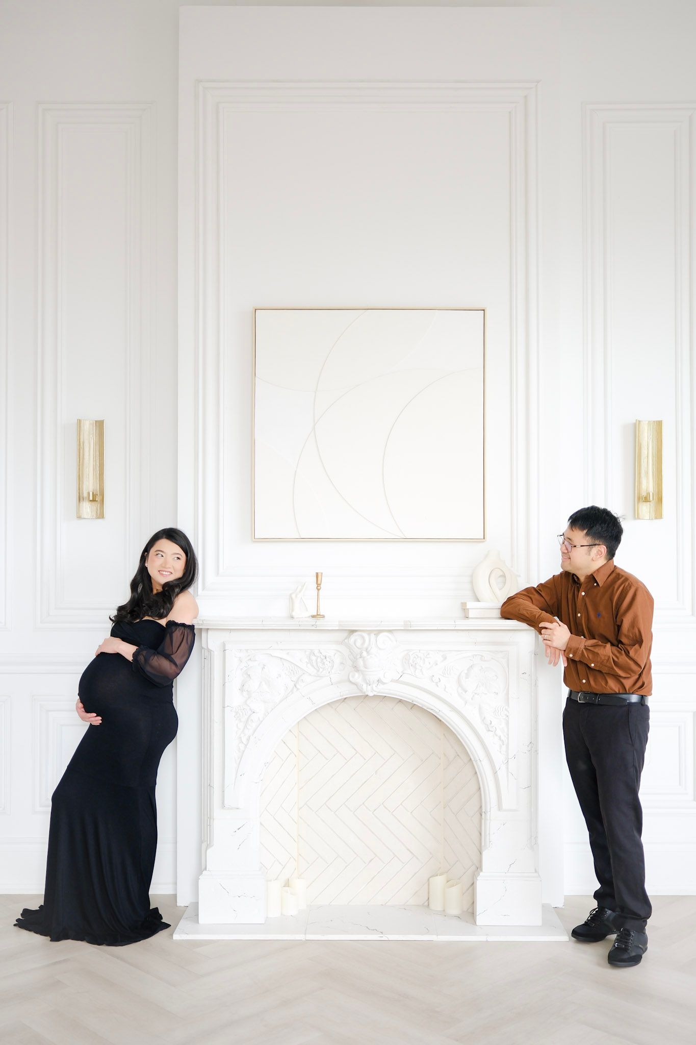 Minimalist photo series showing figures in black and brown clothing posed against white walls and furniture.