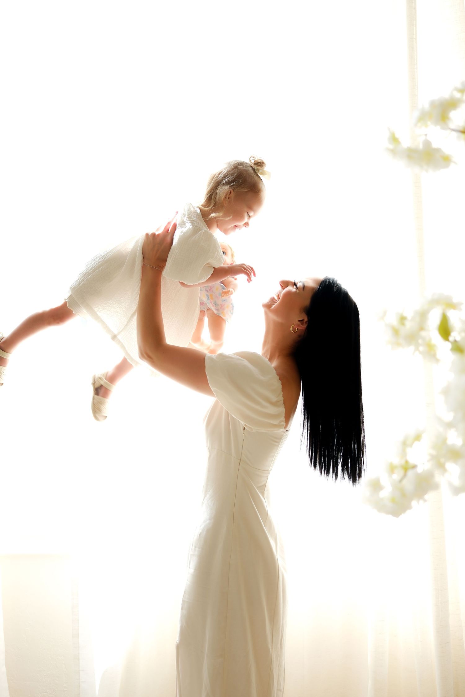 Joyful silhouette of figures in white against backlit window. Toronto, photographer, majestystudios by Nadia, greater toronto area, family