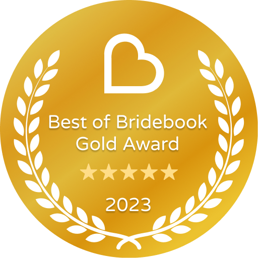 Gold circular award badge for Best of Bridebook 2023 featuring a heart icon and laurel wreath design.