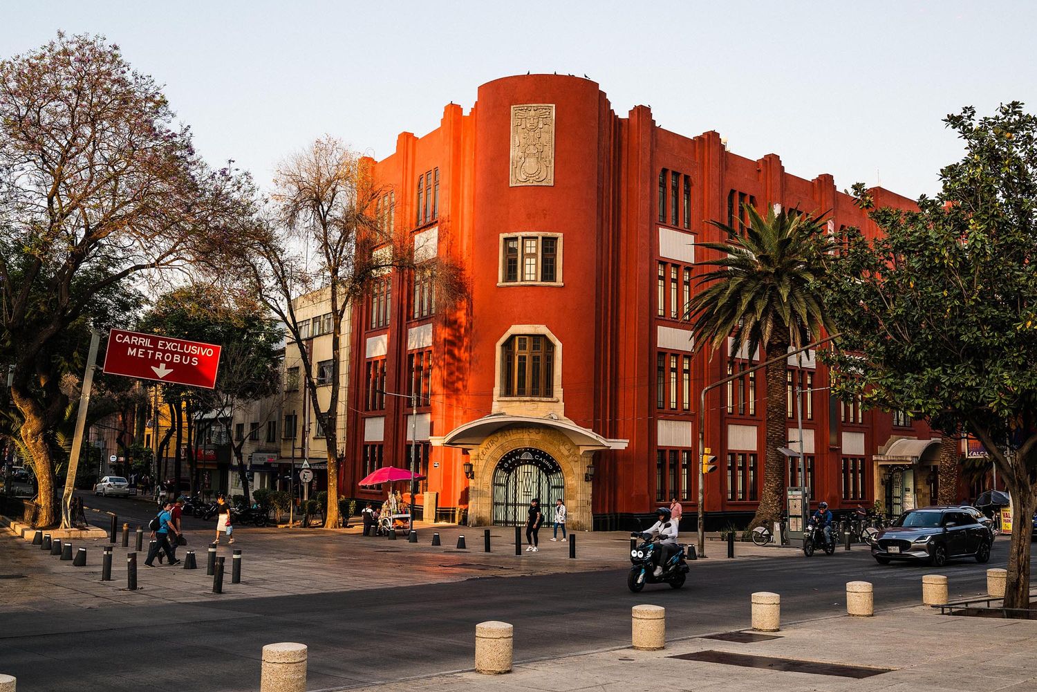 A series of connected images showing a red brick apartment building at different angles during sunset.