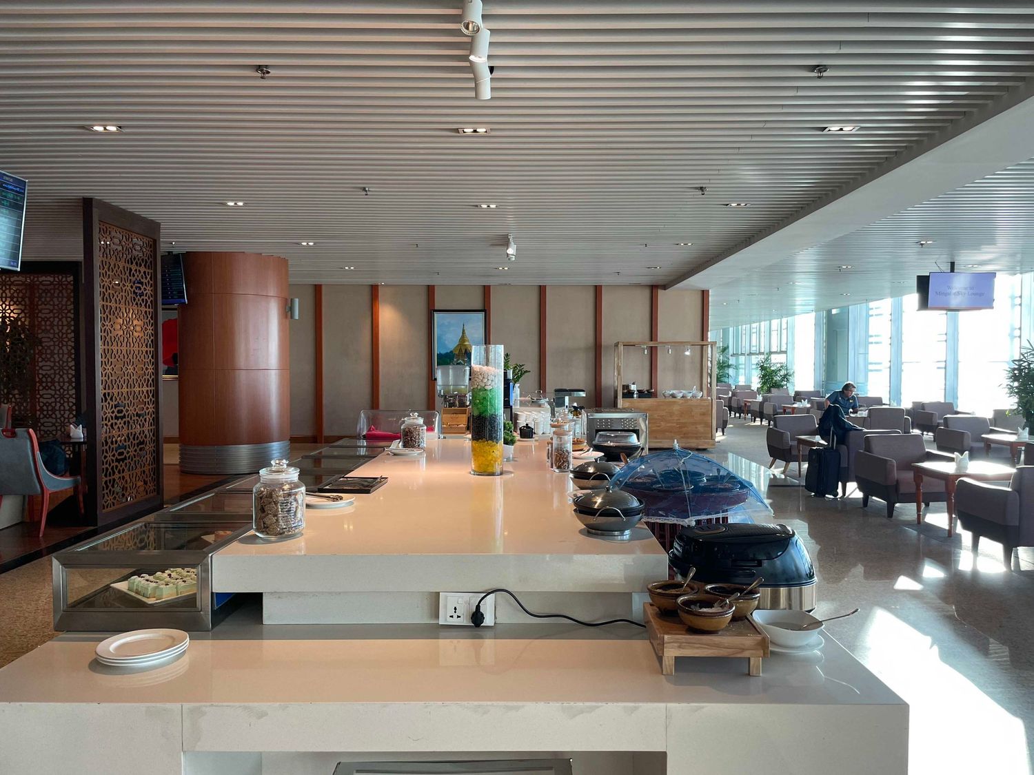 Modern office interior with sleek glass walls, minimalist design and long hallway featuring recessed lighting.