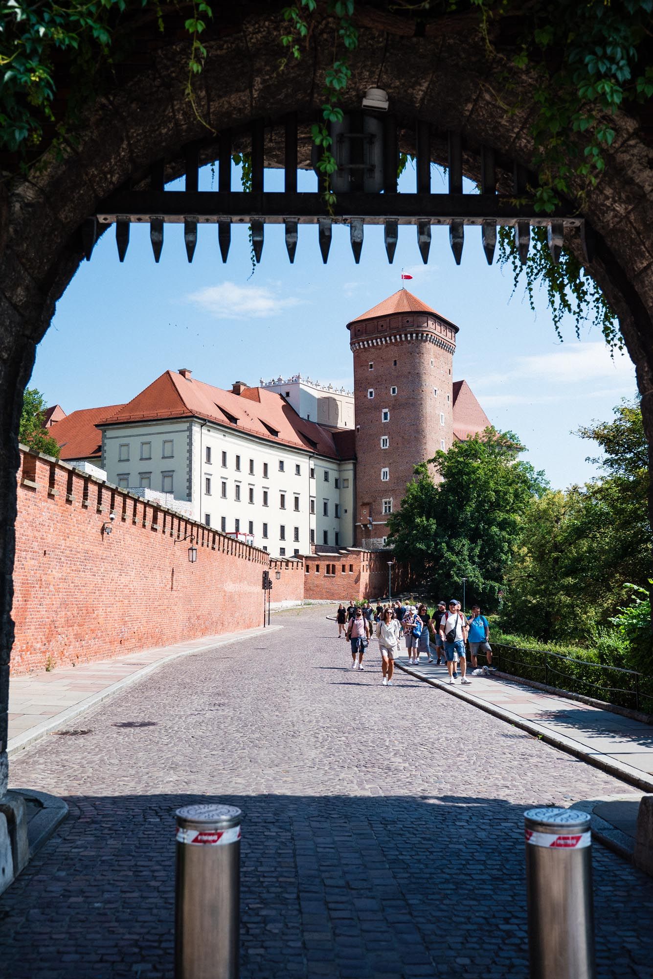 Panoramic view of historic Wawel Castle walls and walkway in Krakow, Poland with red brick fortifications.