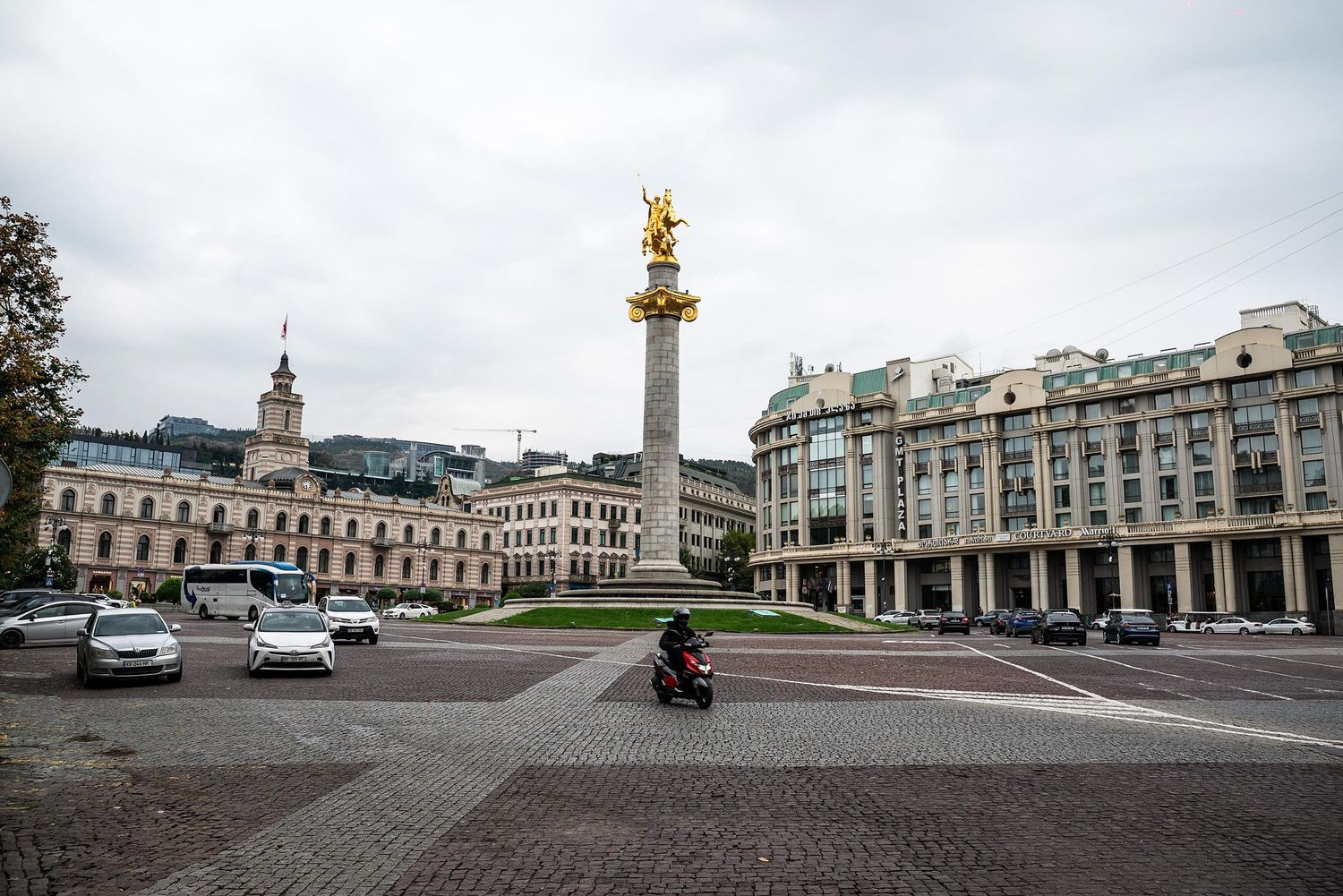 A panoramic view of Freedom Square in Tbilisi, Georgia, with historic architecture and the golden St. George statue.