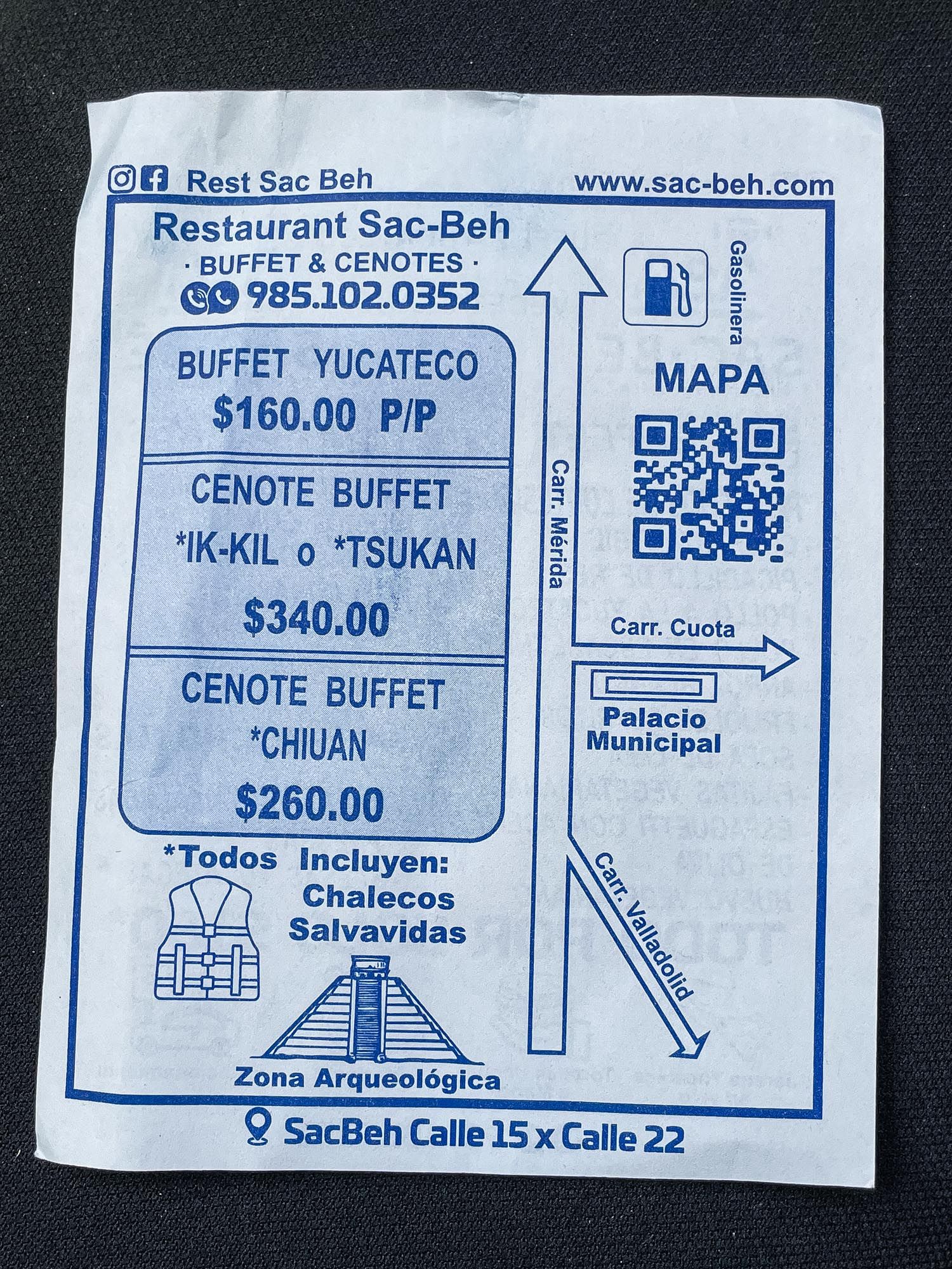 A series of signs and menus advertising Cenote buffet prices and directions at a restaurant in Mexico.