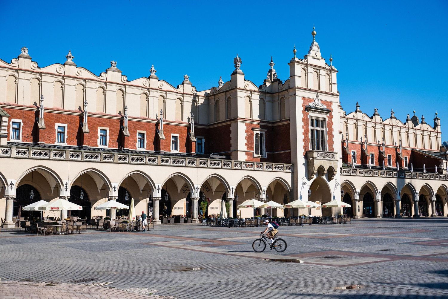 Historic Cloth Hall building with Renaissance architecture and arched colonnade in Krakow's Main Market Square.