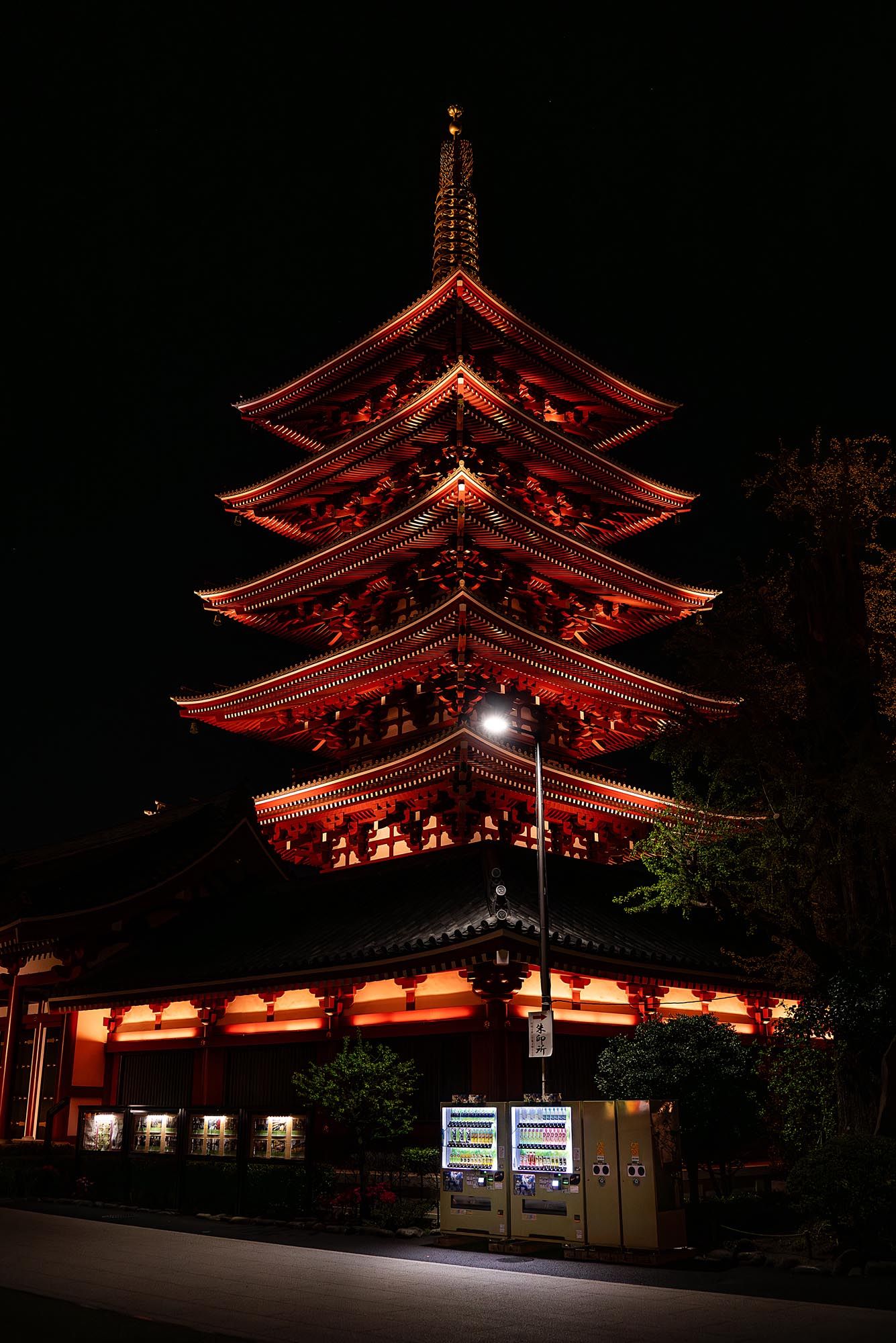 Red illuminated Japanese pagoda temple photographed at night from different angles showing traditional architecture.