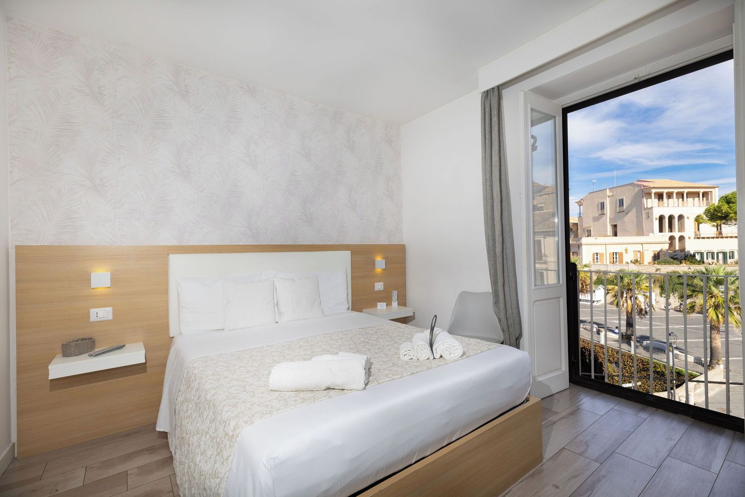 A series of interior photos showing modern hotel rooms with balconies overlooking a sunny beach resort.