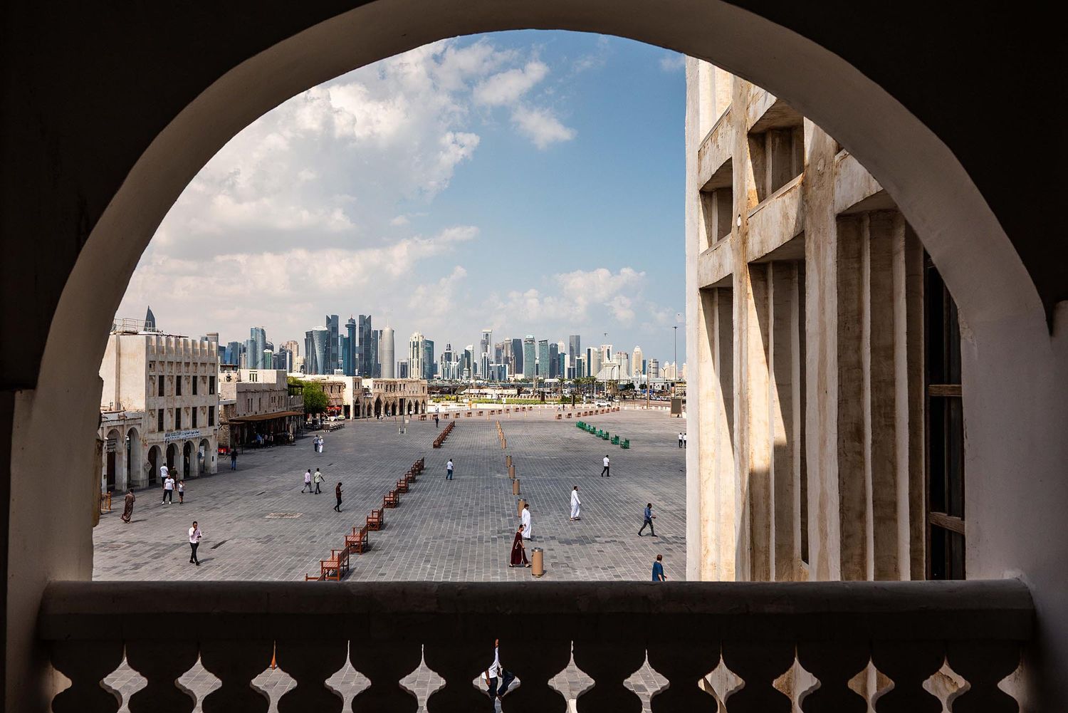 Panoramic view of modern city skyline and arched walkways at the Museum of Islamic Art in Doha, Qatar.