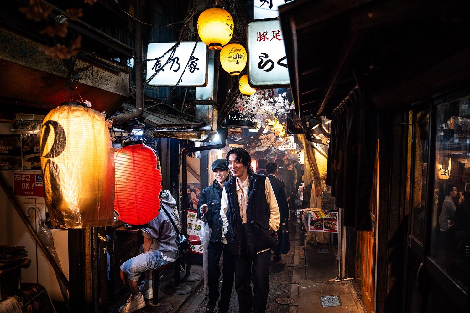 Atmospheric lantern-lit alleyways in Tokyo's traditional Shinjuku Golden Gai district at night.