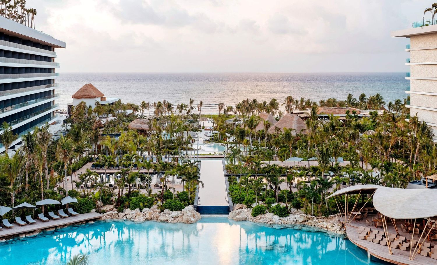 Panoramic collage of luxury beach resort featuring multiple swimming pools, palm trees and modern hotel buildings.
