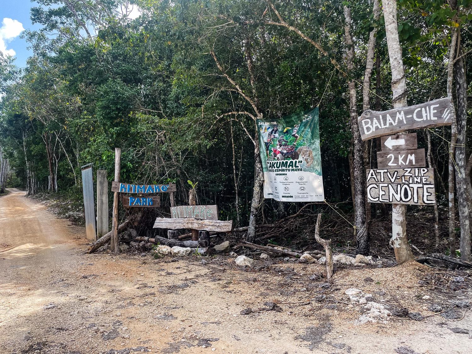 A series of dirt paths and trails through a wooded area with signs posted along the trees.