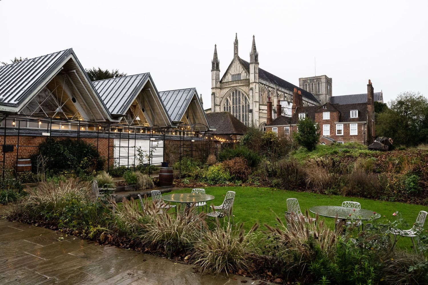 Historic stone church with twin spires and Gothic architecture stands prominently against a cloudy sky.