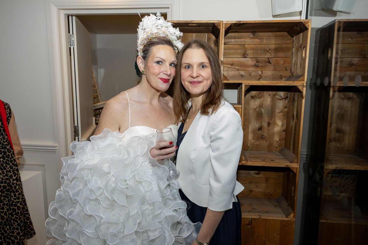 Wedding party members share emotional moments in a rustic wood-paneled venue during pre-ceremony preparations.