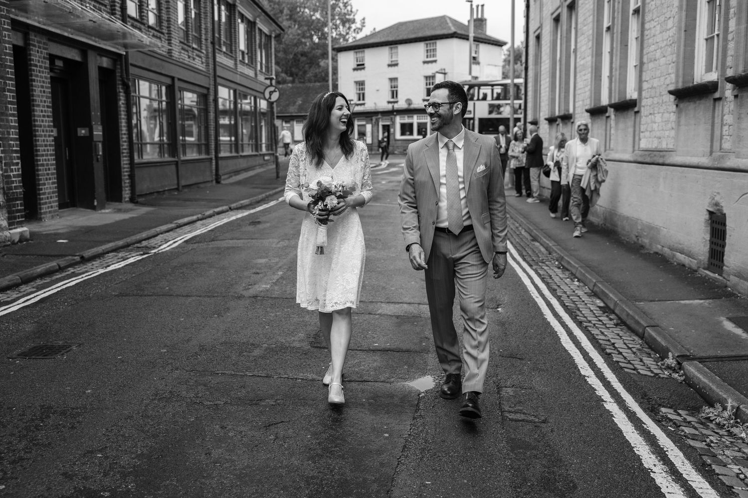 A series of black and white street photographs showing couples walking together down urban pathways.