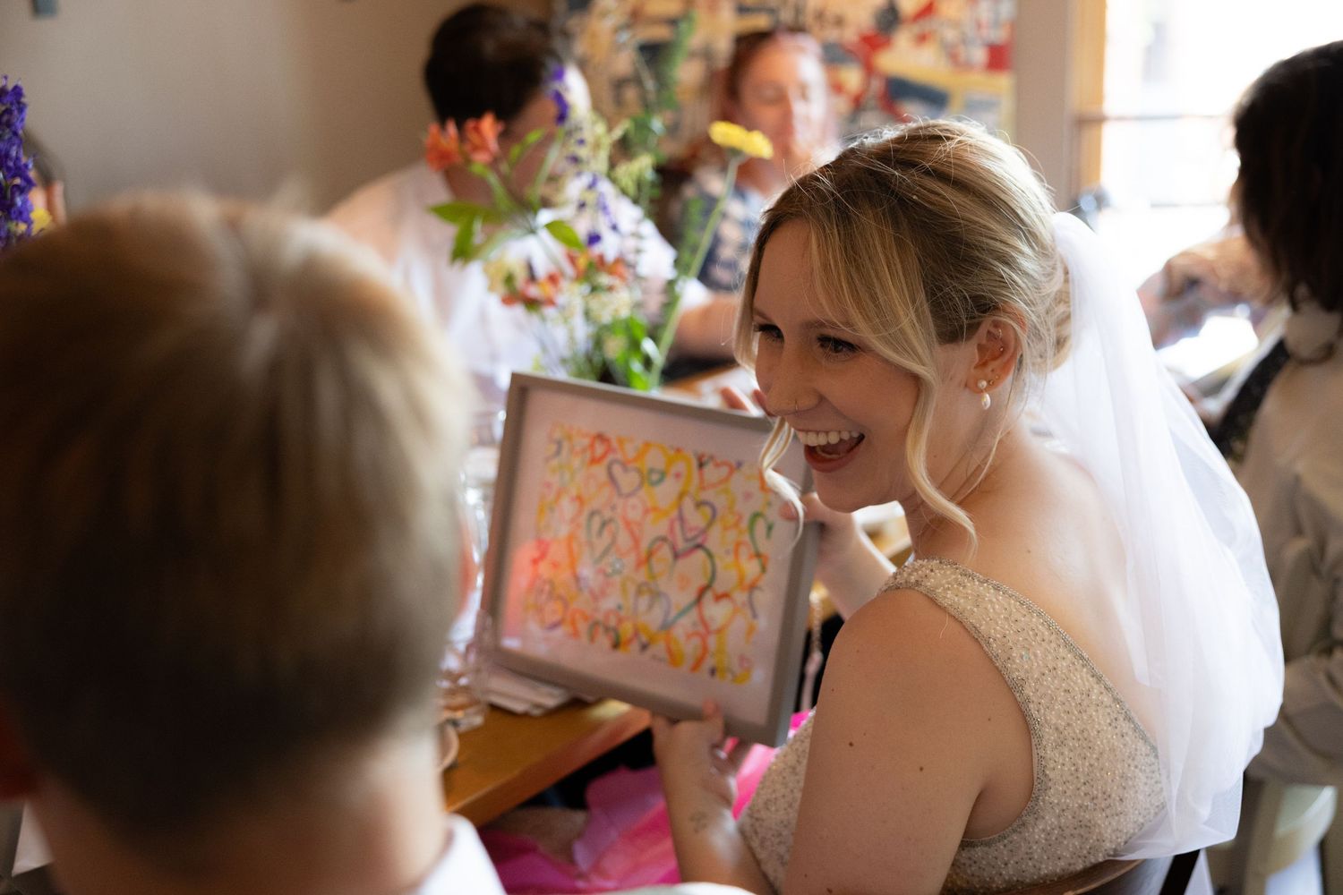 Joyful wedding celebration moment with confetti flying through the air as guests celebrate during a reception.