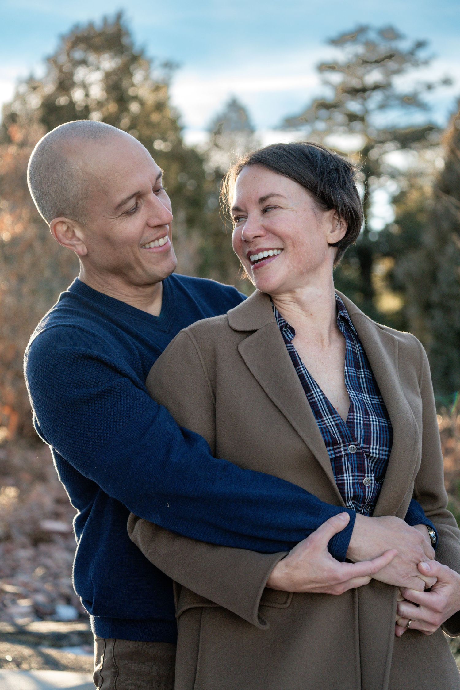 An affectionate couple sharing laughter outdoors during golden hour. Couples photographer colorado springs