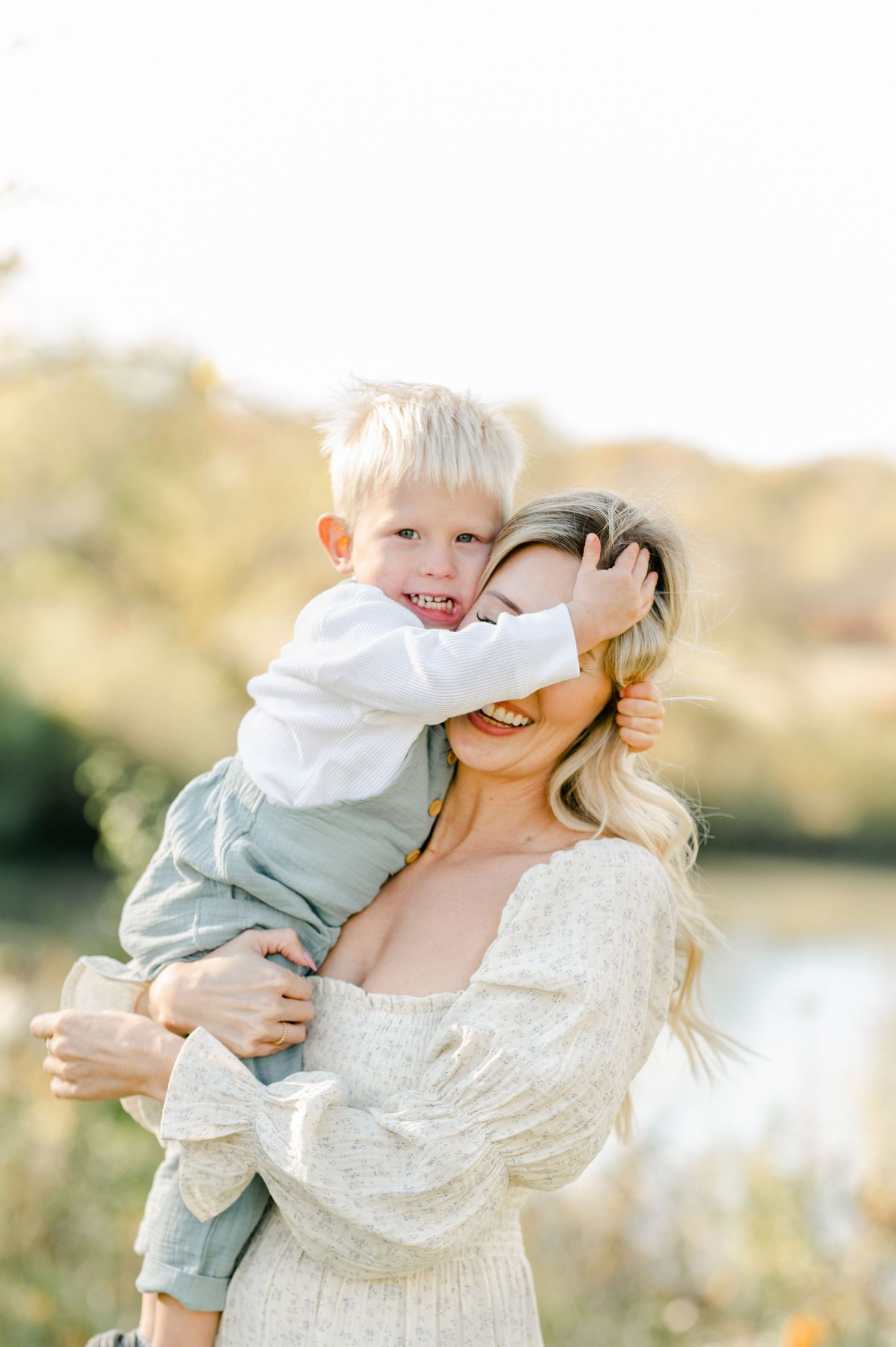 Intimate outdoor portrait session with parent and child in natural lighting.