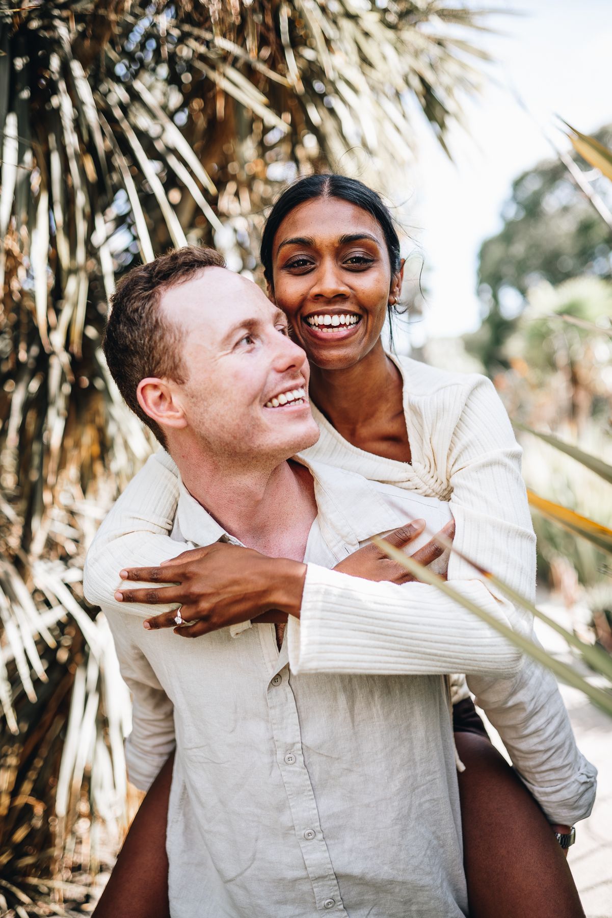 A man piggybacked his fiancé after a successful surprise proposal taken by a Melbourne couples and proposal photographer.