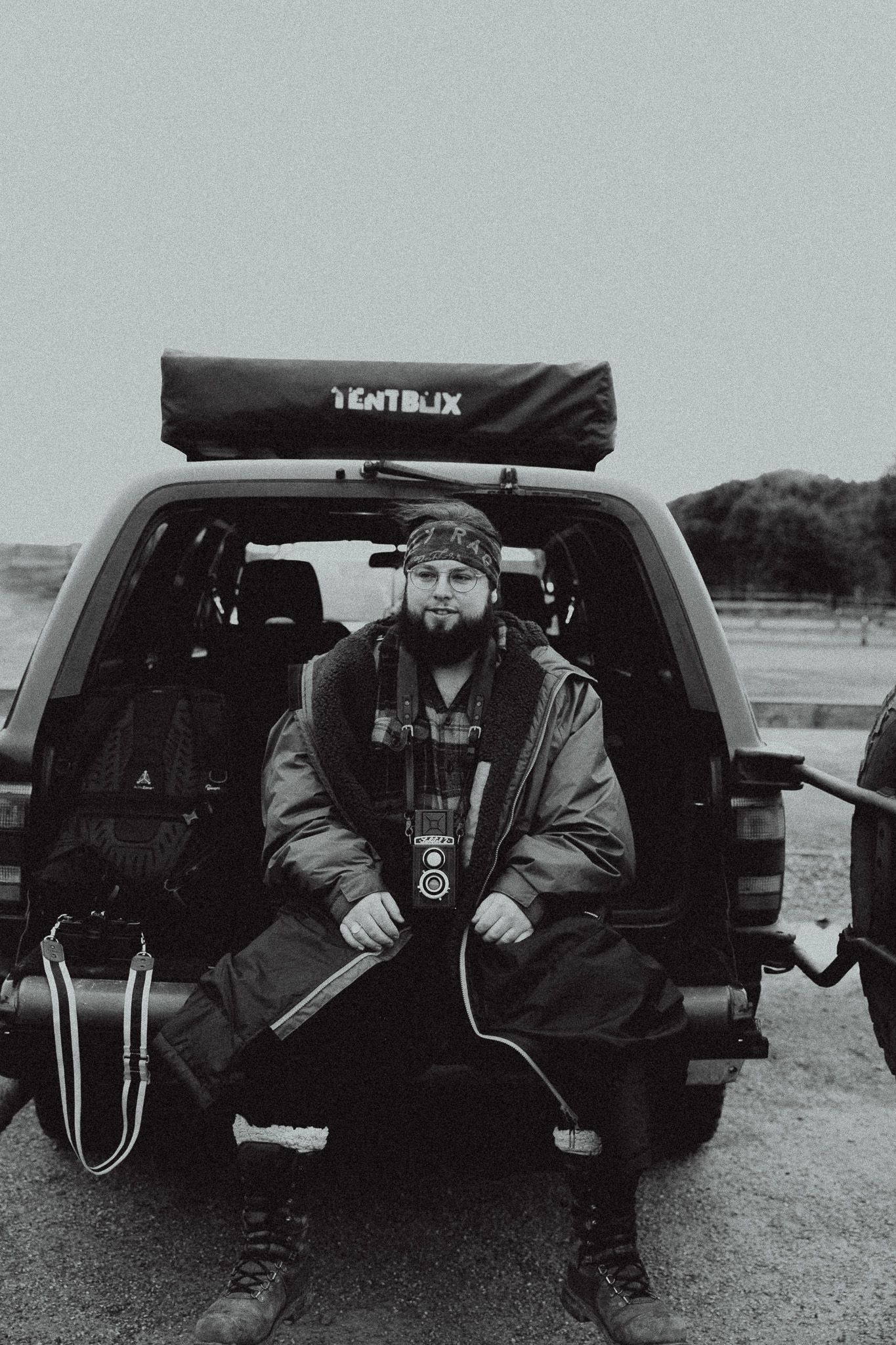 A black and white photo series showing someone sitting in the back of a car in four similar poses.