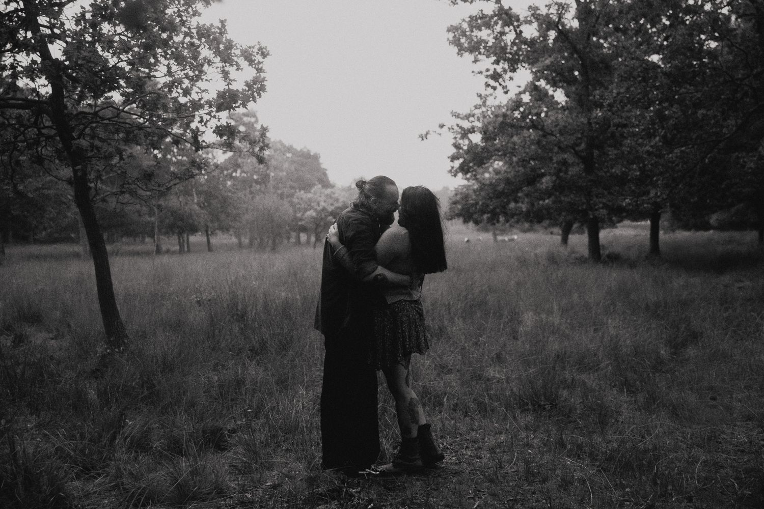 A black and white photo series shows silhouettes of people walking through a misty park landscape.