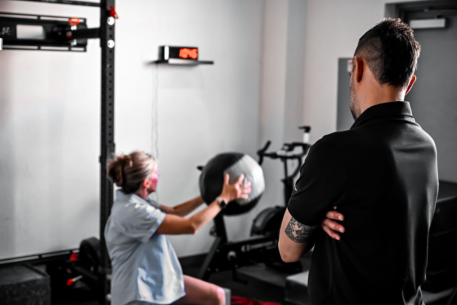 Child and adult practicing boxing moves in modern fitness gym.