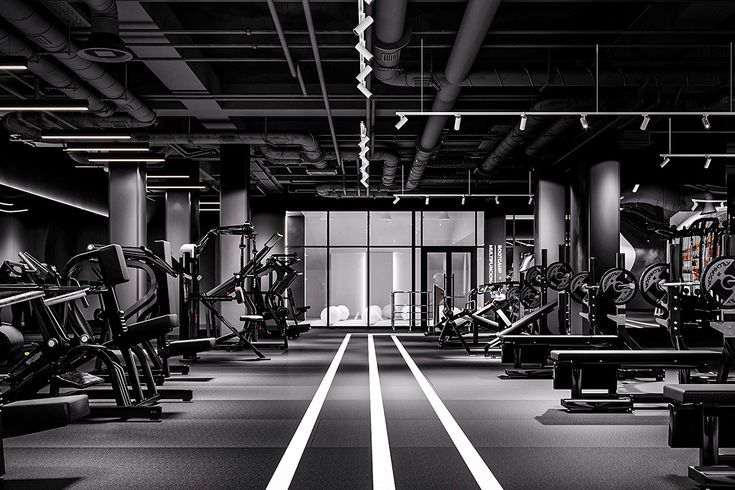 Modern empty gym interior with exercise equipment and striking black and white contrast.