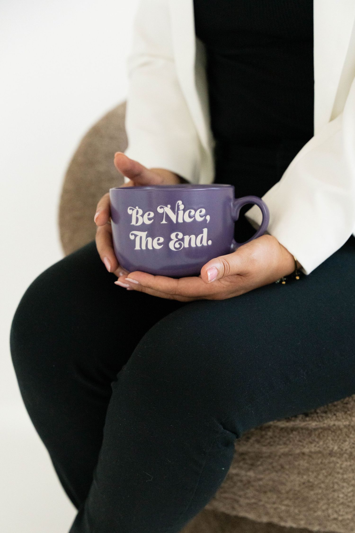 A series of three images showing hands holding dark purple coffee mugs with white text reading 'Be Nice' and 'The End'.