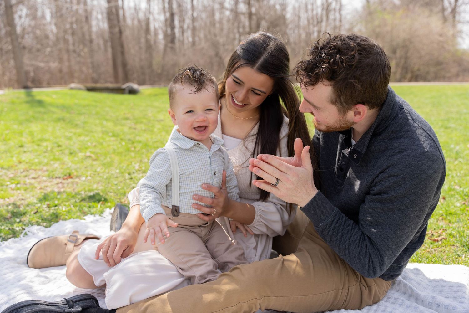 A series of five intimate family photos taken outdoors showing tender moments between parents and baby.