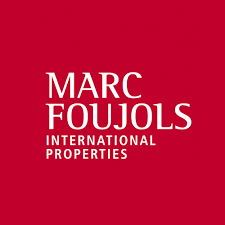 Marc Foujols International Properties real estate agency logo on red background.