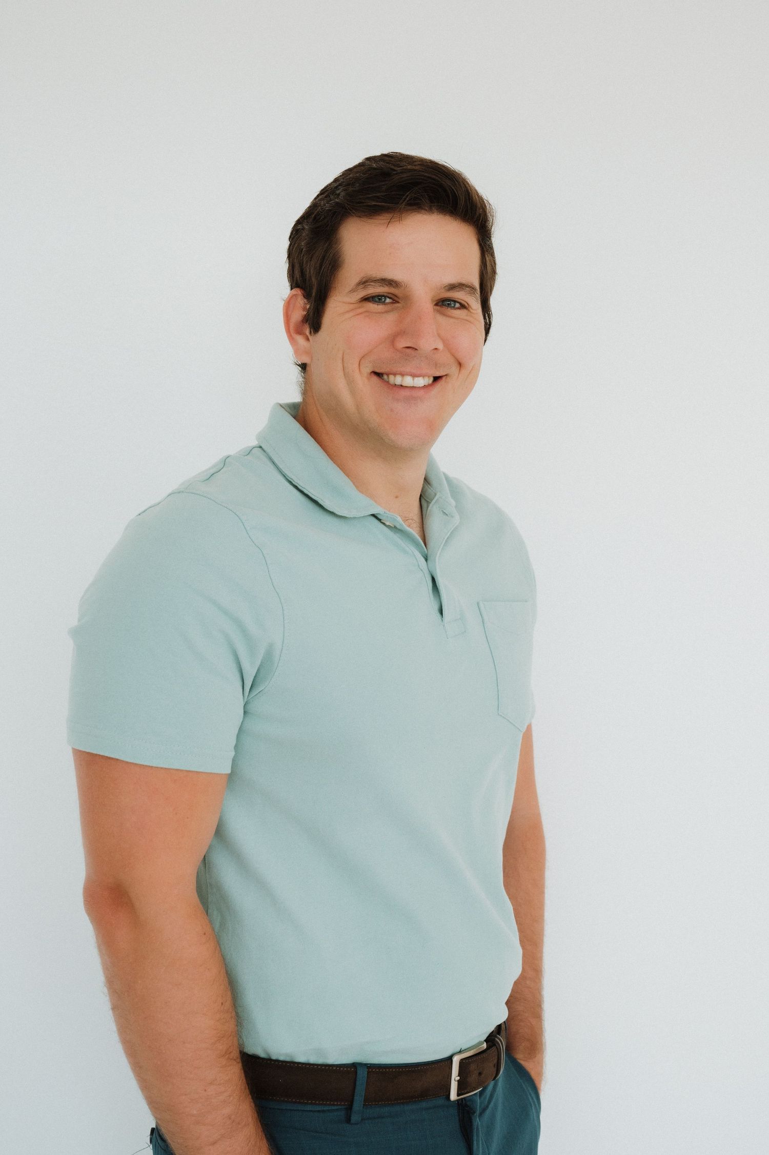 Smiling  CPO Certification Instructor in a mint green polo shirt posing against a white background.