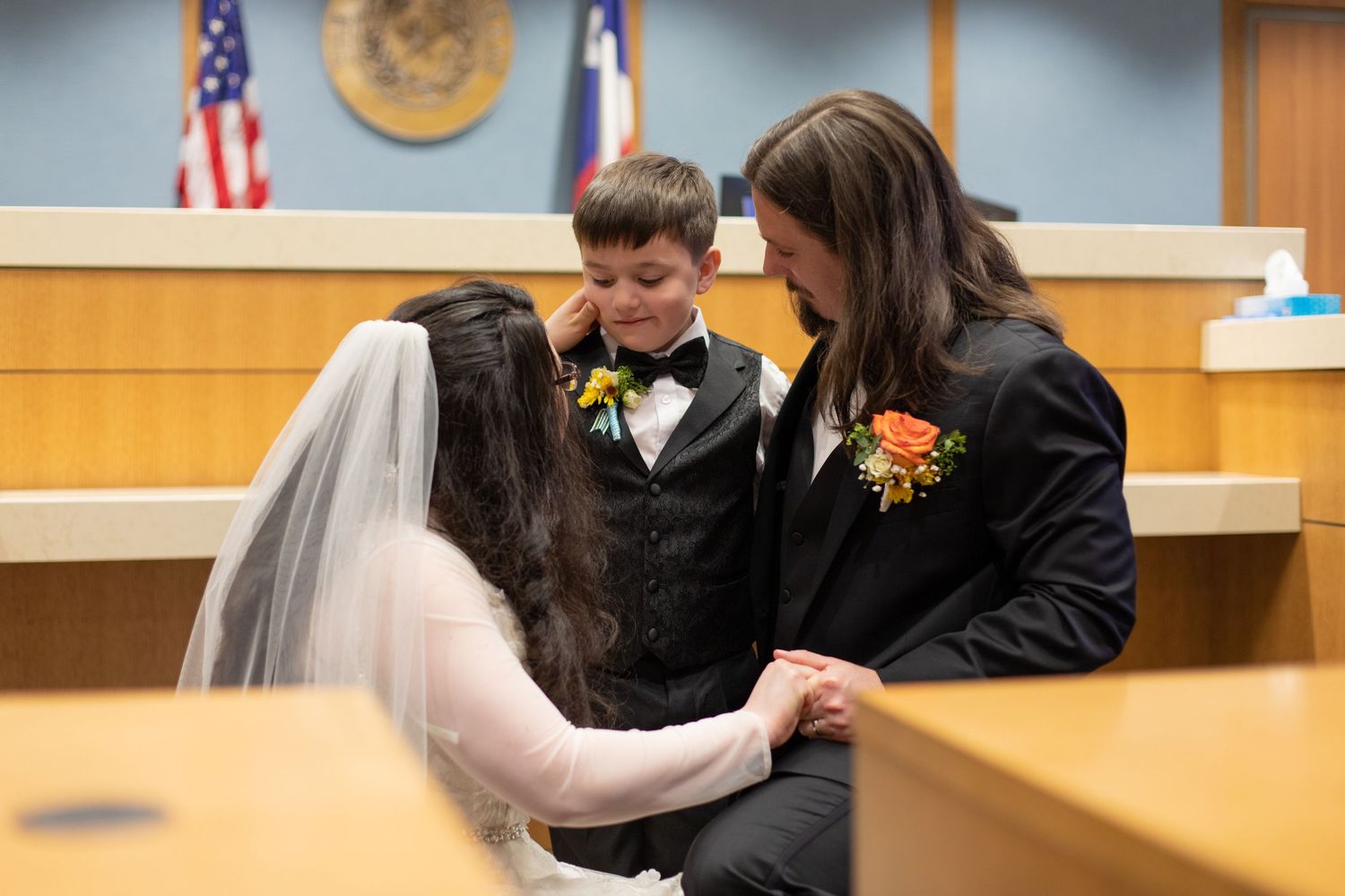 A tender moment between newlyweds during their courthouse wedding ceremony.