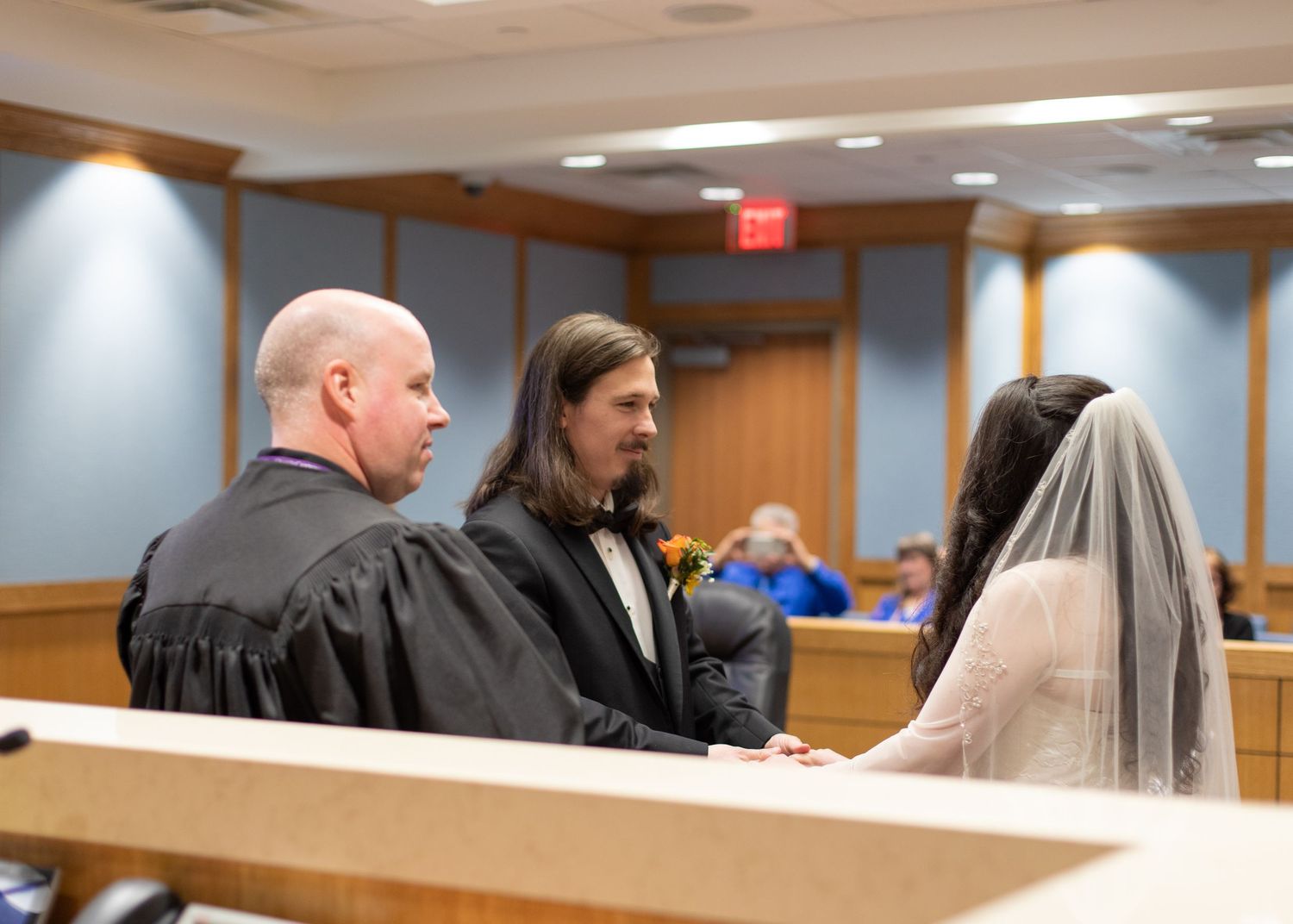 Courthouse wedding ceremony with judge and couple at the bench.